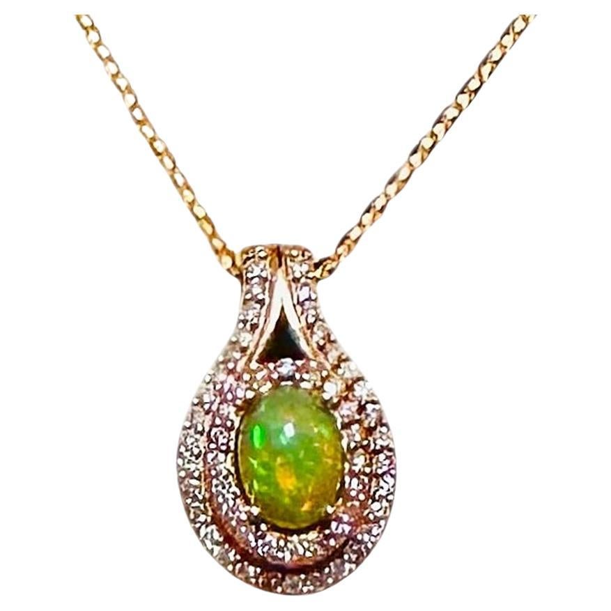 This pendant is just beautiful!  It is 10k Rose Gold and has a 6.5 x 5 mm Fire Opal stone.  The opal is surrounded by 2 rows of brilliant cut diamonds.  It is on a beautiful  14k Italian Rose Gold Chain that is 16 inches long.  The pendant is marked