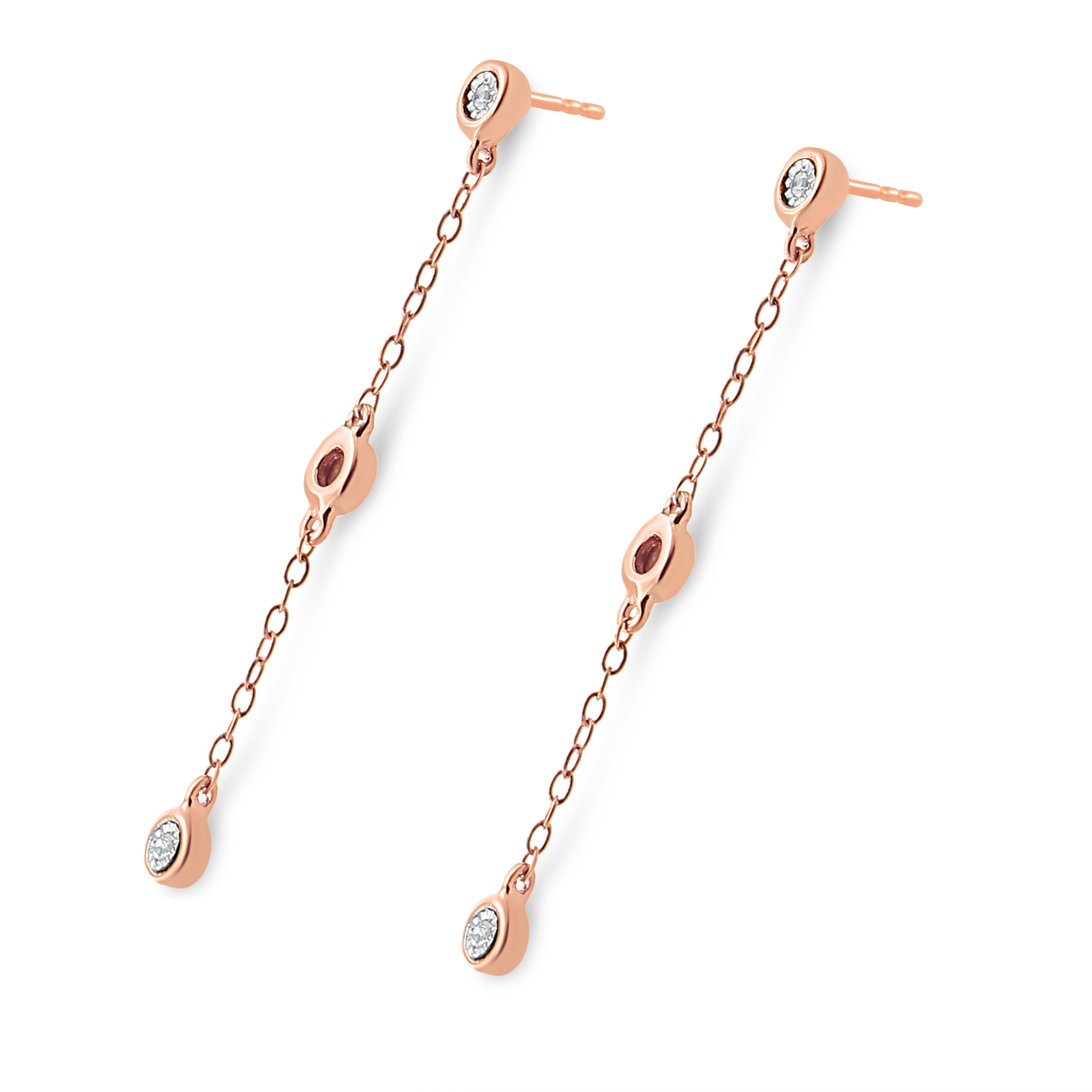 Treat yourself to these lovely and petite 10k rose gold plated .925 sterling silver dangle earrings. Each earring is set with 3 natural, round-cut diamonds in a miracle setting evenly spread out down. The diamonds have a total carat weight of 1/15