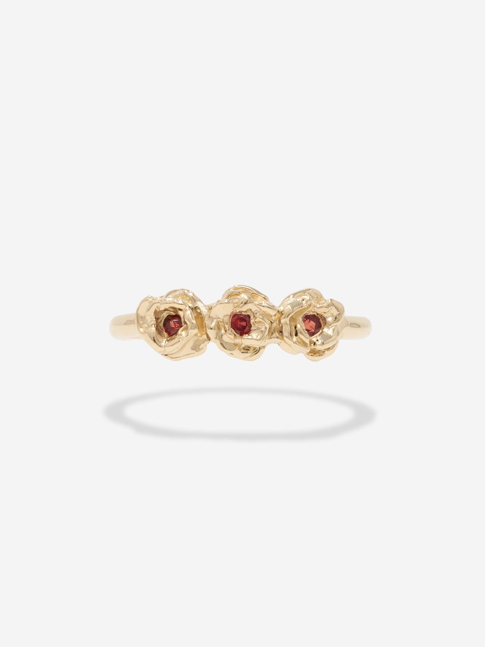 CAPTIVE - A one-of-a-kind hand carved rose ring cast in solid 10k gold and set with three 2mm red sapphires.