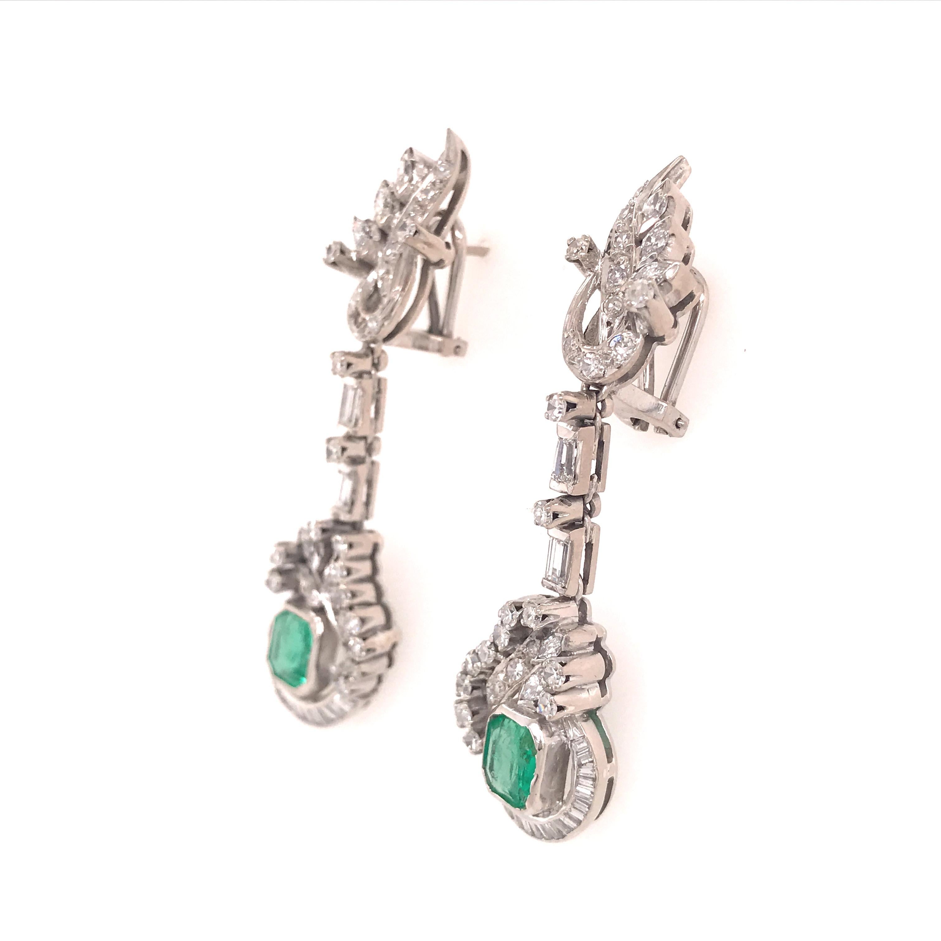 Edwardian Diamond and Emerald Earring in Sterling Silver and 10K White Gold.  (10) Marquise Diamonds, (52) Round Brilliant Cut and (40) Baguette Diamonds weighing 2.20 carat total weight, G-I in color, VS-SI in clarity and (2) Emeralds weighing