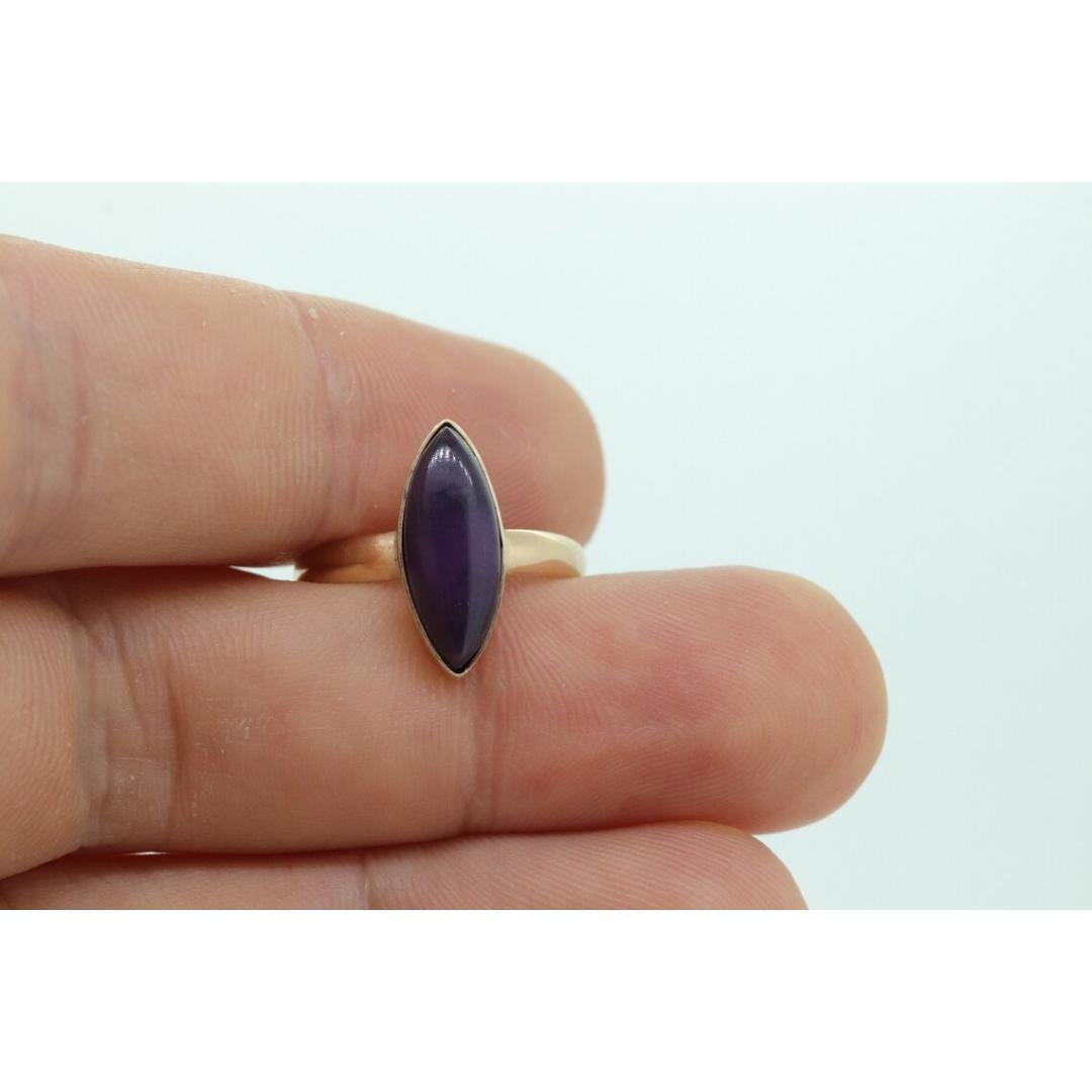 Vintage from the 1910s
Size: 7 1/4 US
Materials: Gold
Gemstone: Sugilite
Gem color: Colorless

Band color: Gold

Very rare signet ring.

10k Yellow gold Marquise cabochon top Purple Sugilite ring.

Condition: Has not been polished. Tiny scratches