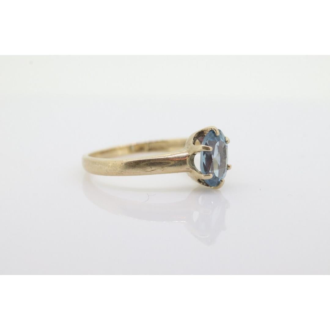 10k Topaz Solitaire Ring. 10k yellow gold HANDWROUGHT Blue Oval Topaz solitaire For Sale 1