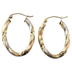 10k Tri-Color Gold Diamond-Cut and Textured Oval Twisted Hoop Earrings #23096