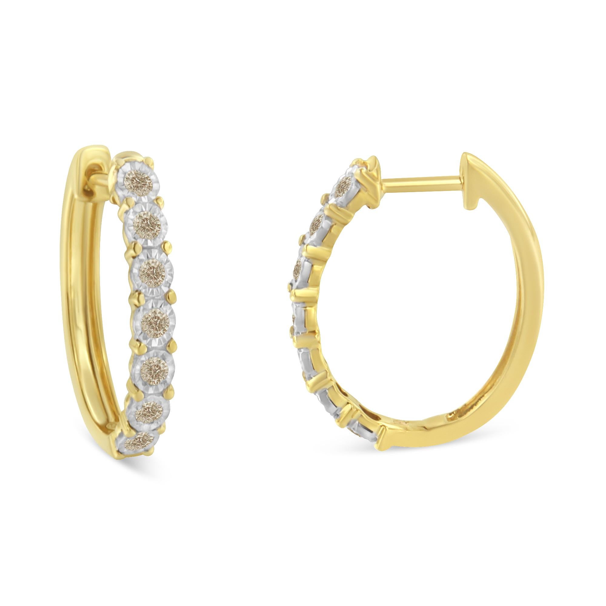 This pair of hoop earrings features shimmering diamonds set in 10 karat two-tone gold. Each earring has seven round diamonds set in a miracle setting to enhance their brilliance. The total diamond weight is .50 carats. They are built with leverback