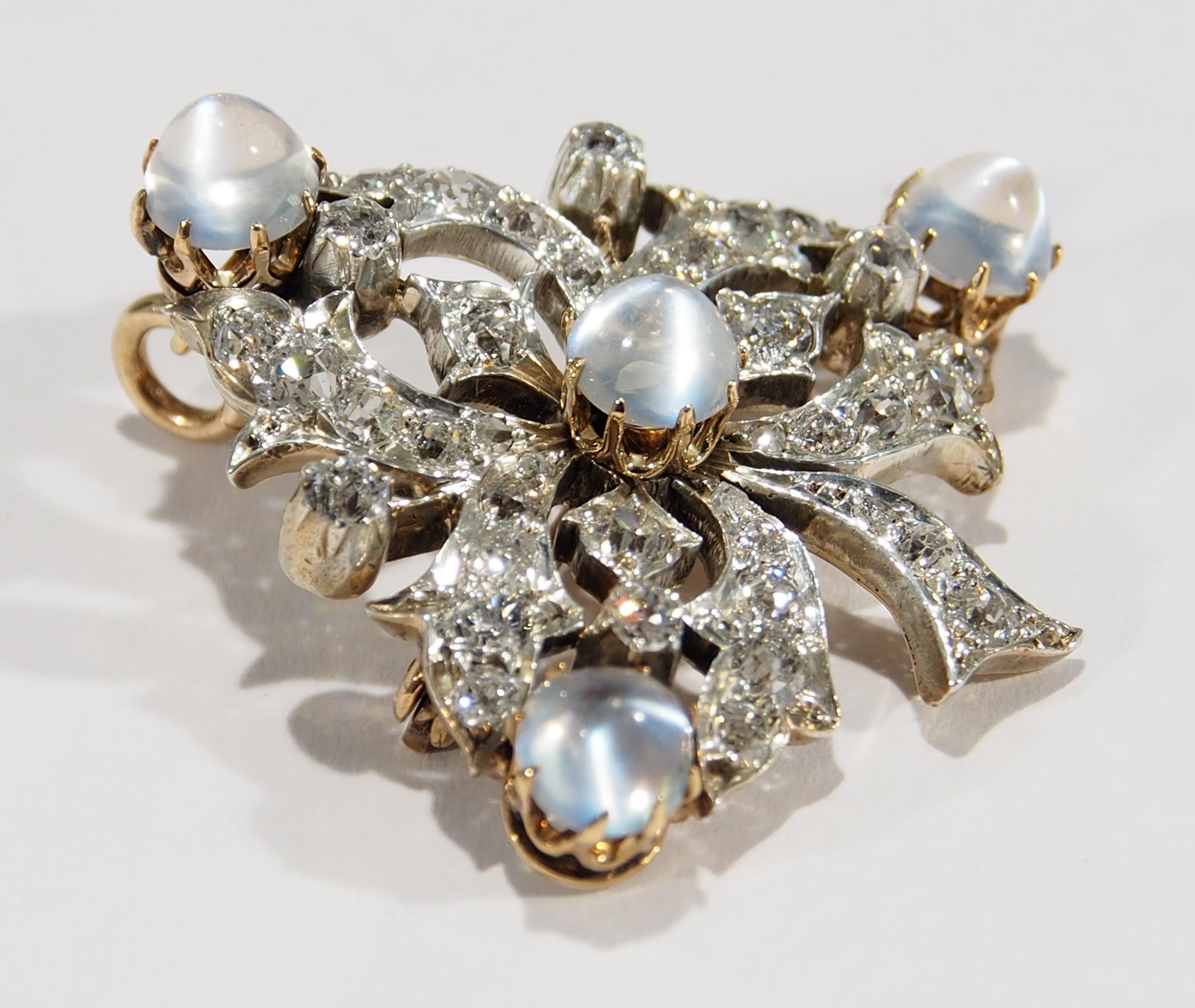 This is a stunning example of Victorian Jewelry a Silver and 10K White Gold Brooch reminiscent of a Grape Cluster set with (4) Moon Stones, approximately 3.0ctw  and 36 Rose Cut Diamonds.  The Diamonds are G-I in color, VS-I1 in Clarity and