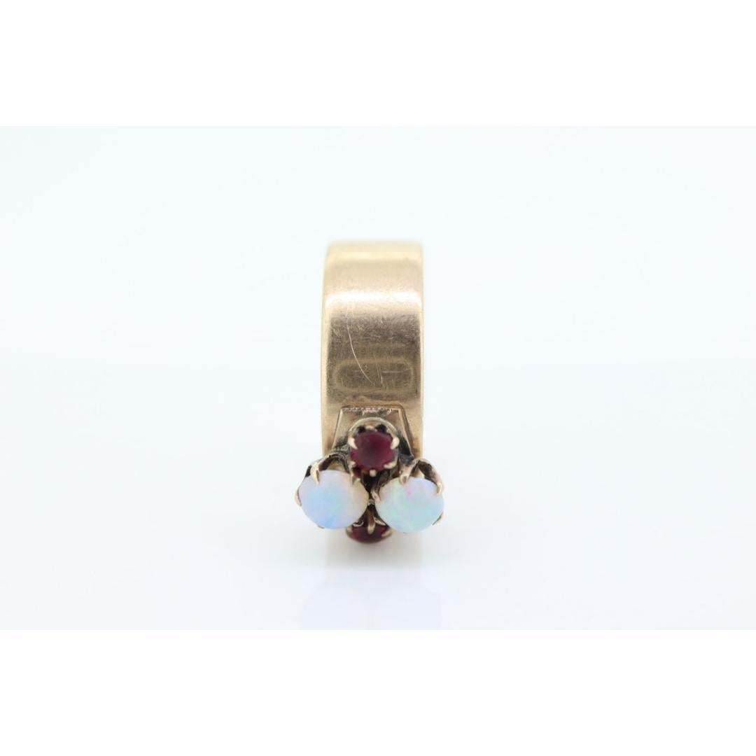 Vintage from the 1900s
Size: 7 1/4 US
Materials: Stone
Gemstone: Opal
Gem color: White
Band color: Gold

Style: Victorian

10k gold Marked tests appropriately JCS
4.5mm twin opals.
3mm garnets
2.8grams total weight
6.5 mm shank

Stunning ring. Will