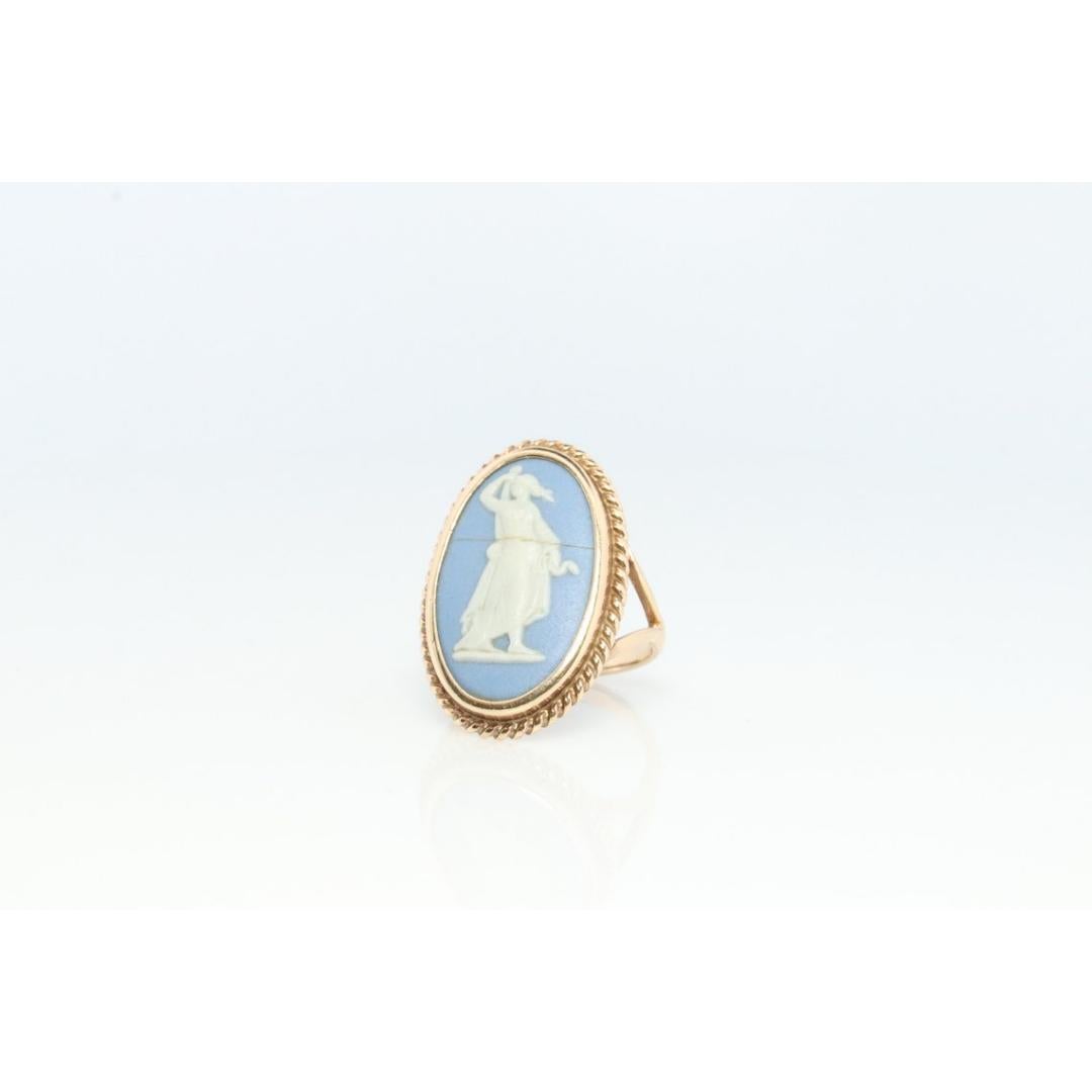 Vintage from the 1960s
Size: 5 1/2 US
Materials: Stone
Gem color: Brown

Band Color: Gold

Rare Wedgwood Blue Ceramic Cameo ring.

Made in England.

Condition: Has a hairline crack. The crack has been stabilized and repaired. Please purchase