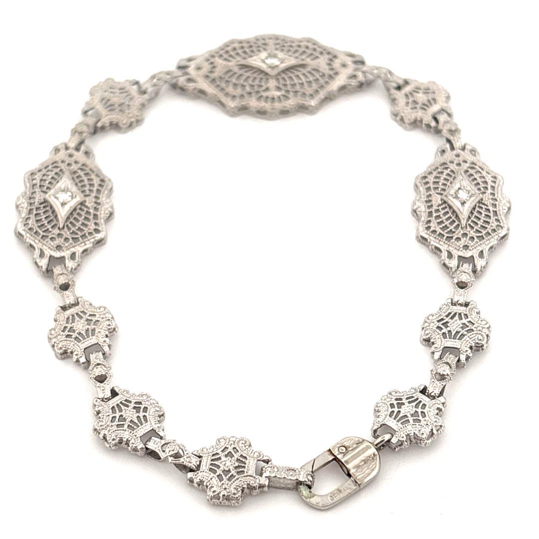This exquisite vintage bracelet by ESEMCO is finely crafted in 10K white gold and showcases the brand's signature attention to detail. Featuring a series of intricately designed openwork panels, the bracelet exudes the elegance of the Art Deco era.