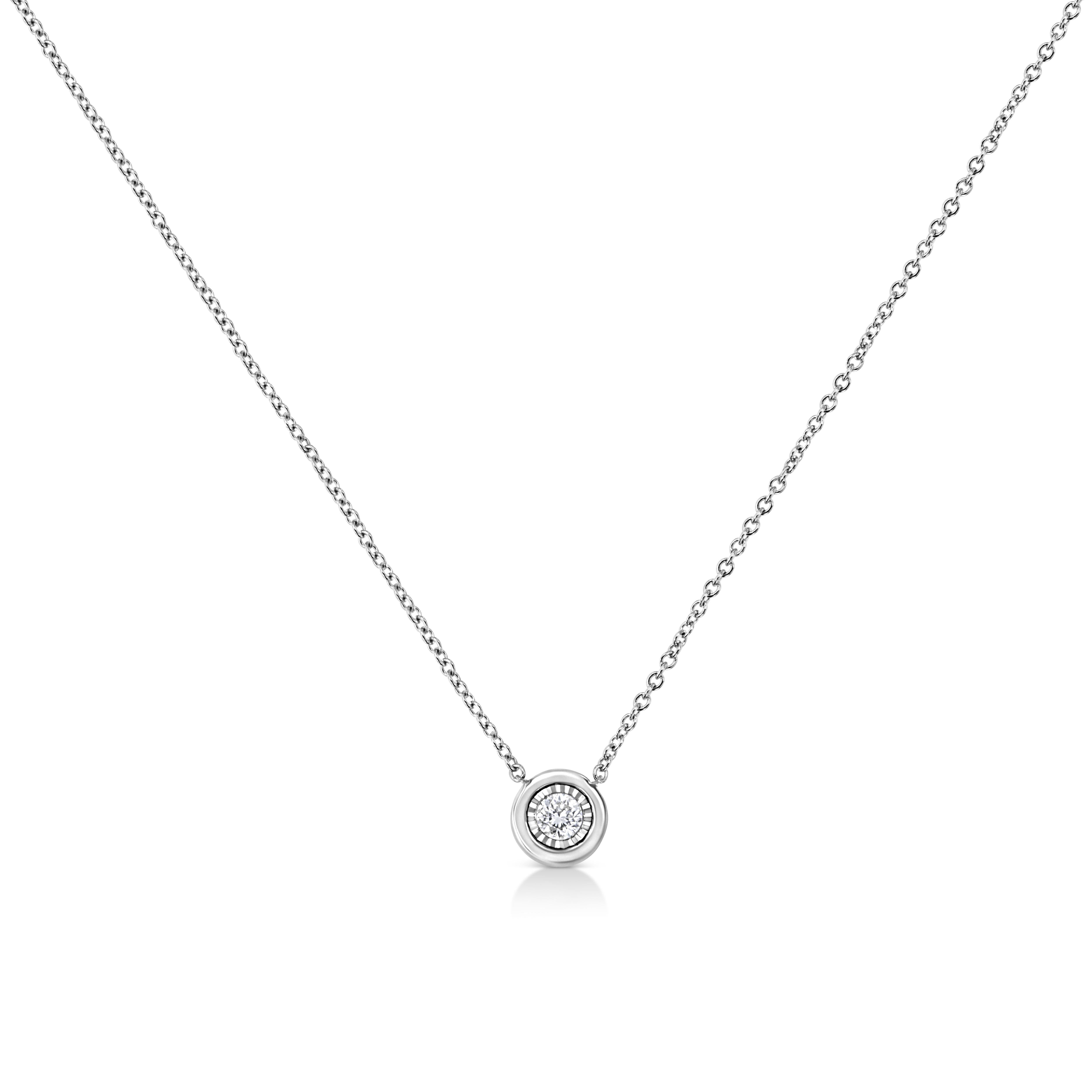 This simple and elegant pendant necklace features a single round brilliant cut diamond. It is the perfect choice to add a little sparkle to any outfit. Crafted in 10 karat white gold, it has a total diamond weight of 1/10 carats. This beautiful