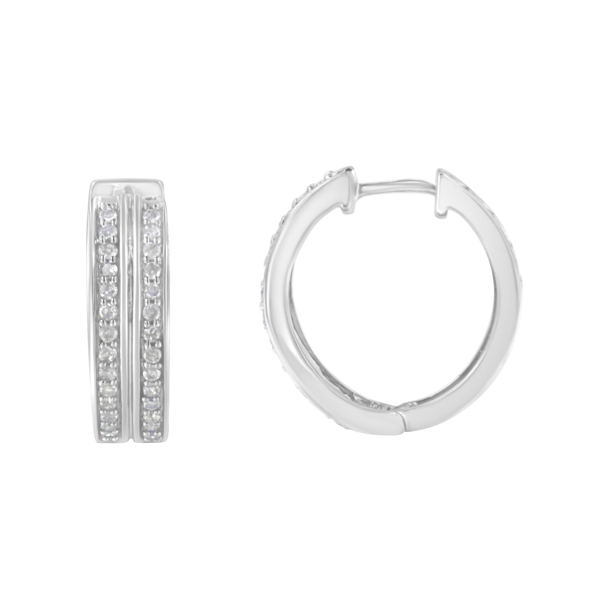 Exuberant hoop earrings made with 10k white gold and genuine diamonds. The round format of the earring contains 56 diamonds with a cut-shape and a pave setting. This silver-plated colored jewelry piece comes with lever-backs and presents a 1/2ct