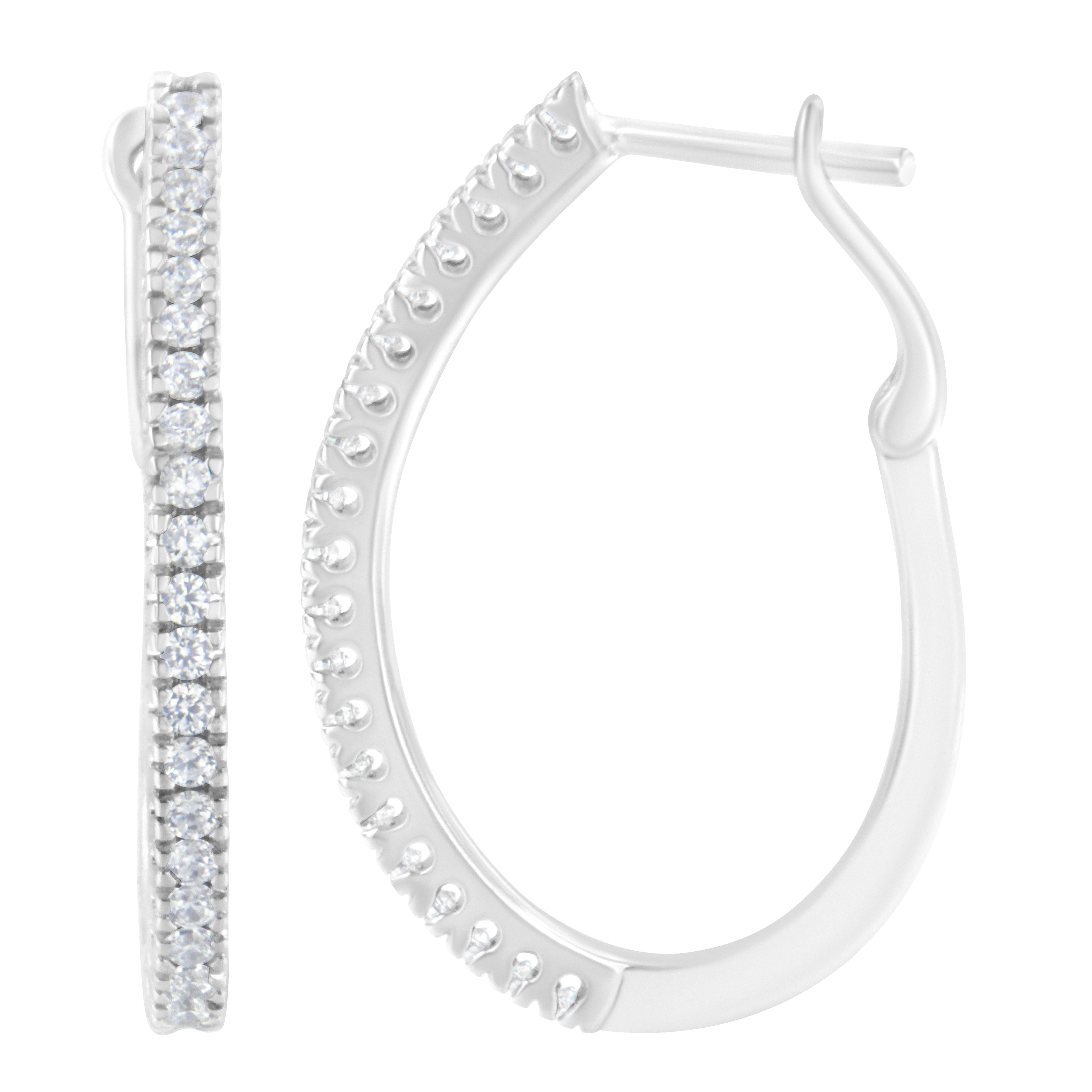 
Introducing our exquisite 10KT White Gold 1/2 cttw Diamond Hoop Earrings (I-J, I2-I3), designed to elevate your ensemble with timeless elegance and unmatched sparkle.

Crafted from luminous 10k white gold, these captivating hoop earrings boast a