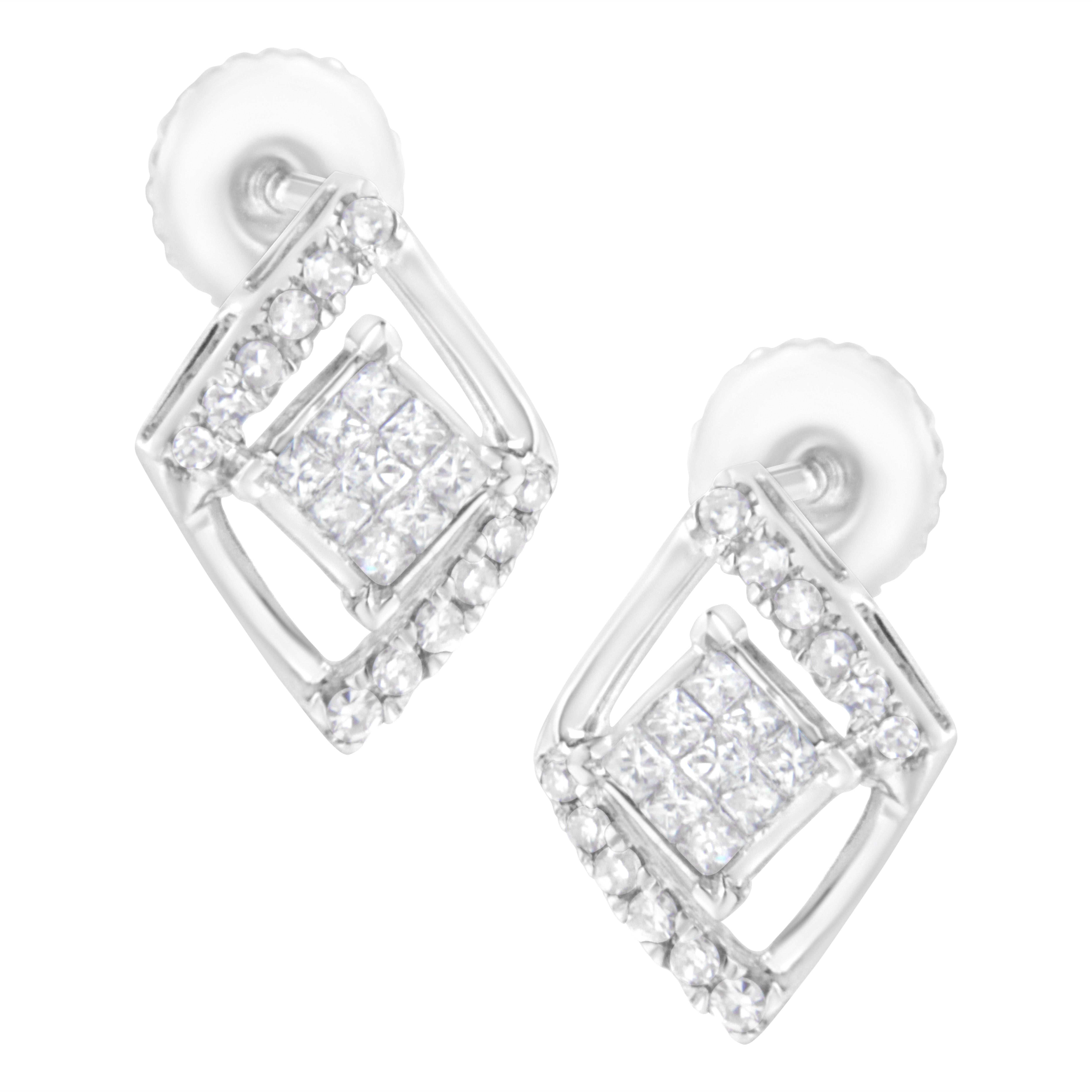 Stand out with these stunning geometrical shaped studs. Shimmering princess cut diamonds in an invisible setting create a square cluster that sits inside a rhombus shaped floating halo. The halo is inlaid on two opposite sides with round cut