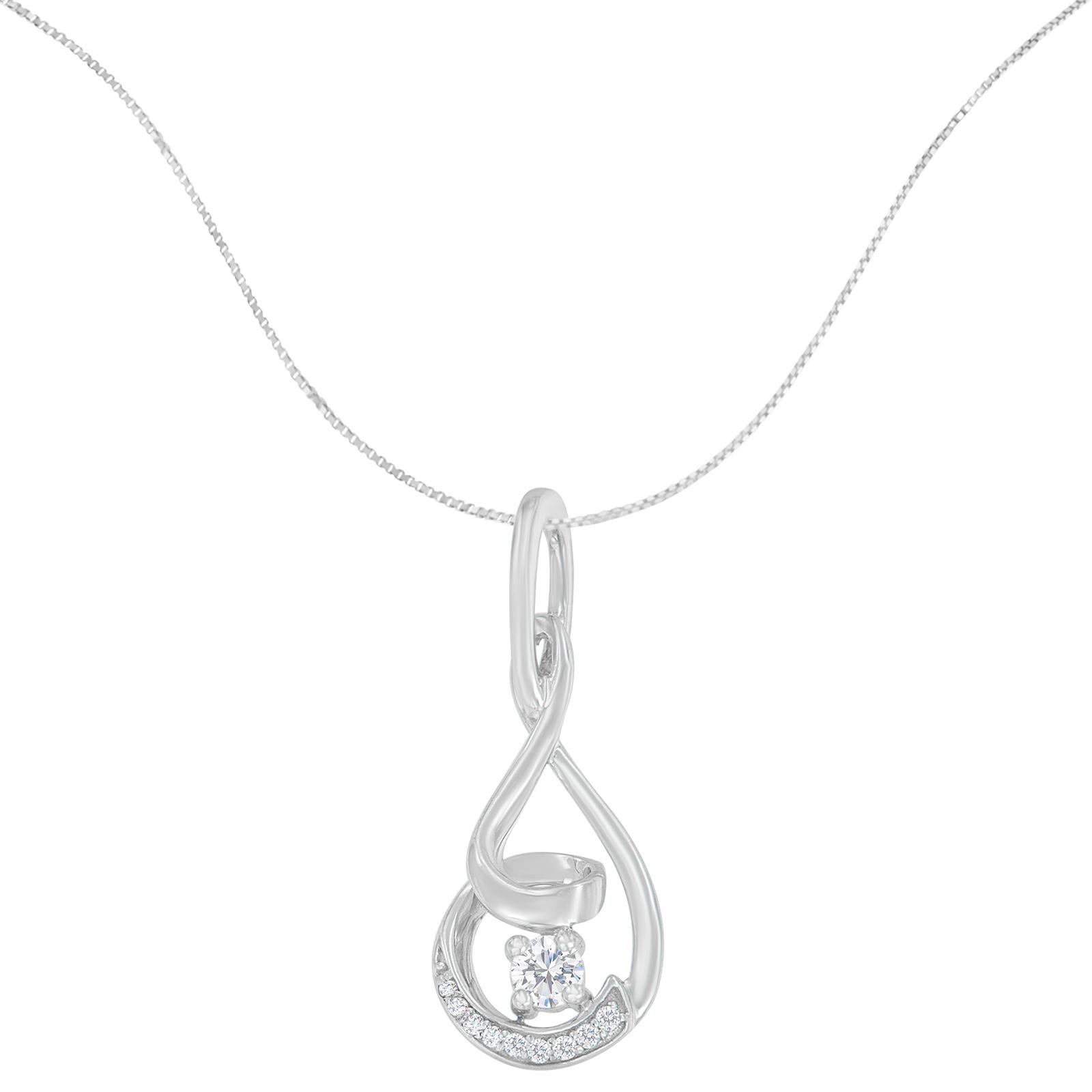 Swirls of white gold are linked together, creating an eye-catching contrast for this unique pendant necklace. A sprinkling of diamonds line the outer layer, while a single stone adorns the center, lending style and elegance. This beautiful necklace