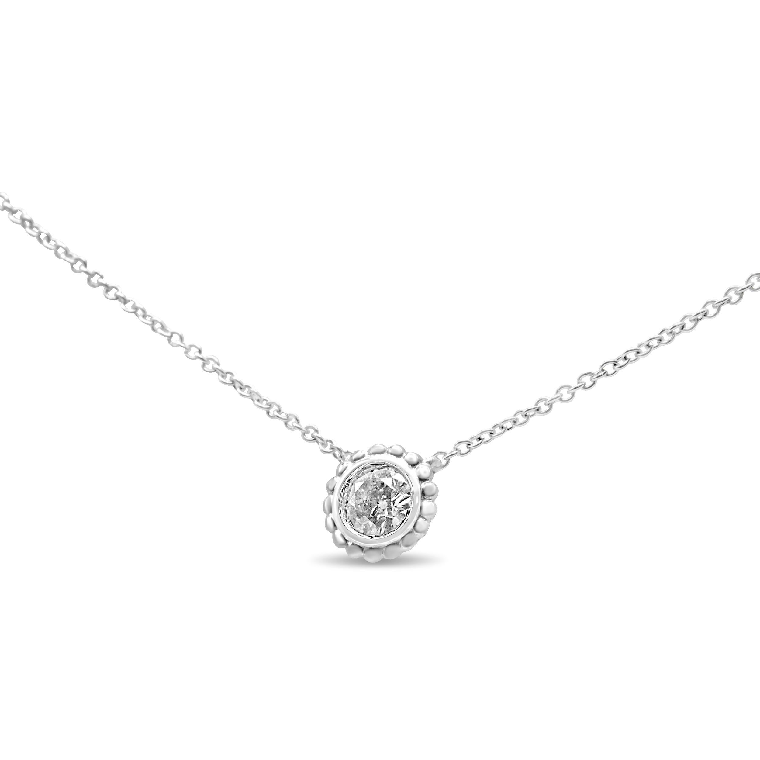 Masterfully set in a unique motif, this diamond solitaire pendant necklace takes on a sweet design with the 10k white gold forming a budding floral-silhouette that halos the singular center stone. The centerpiece of this sweet and simple motif is