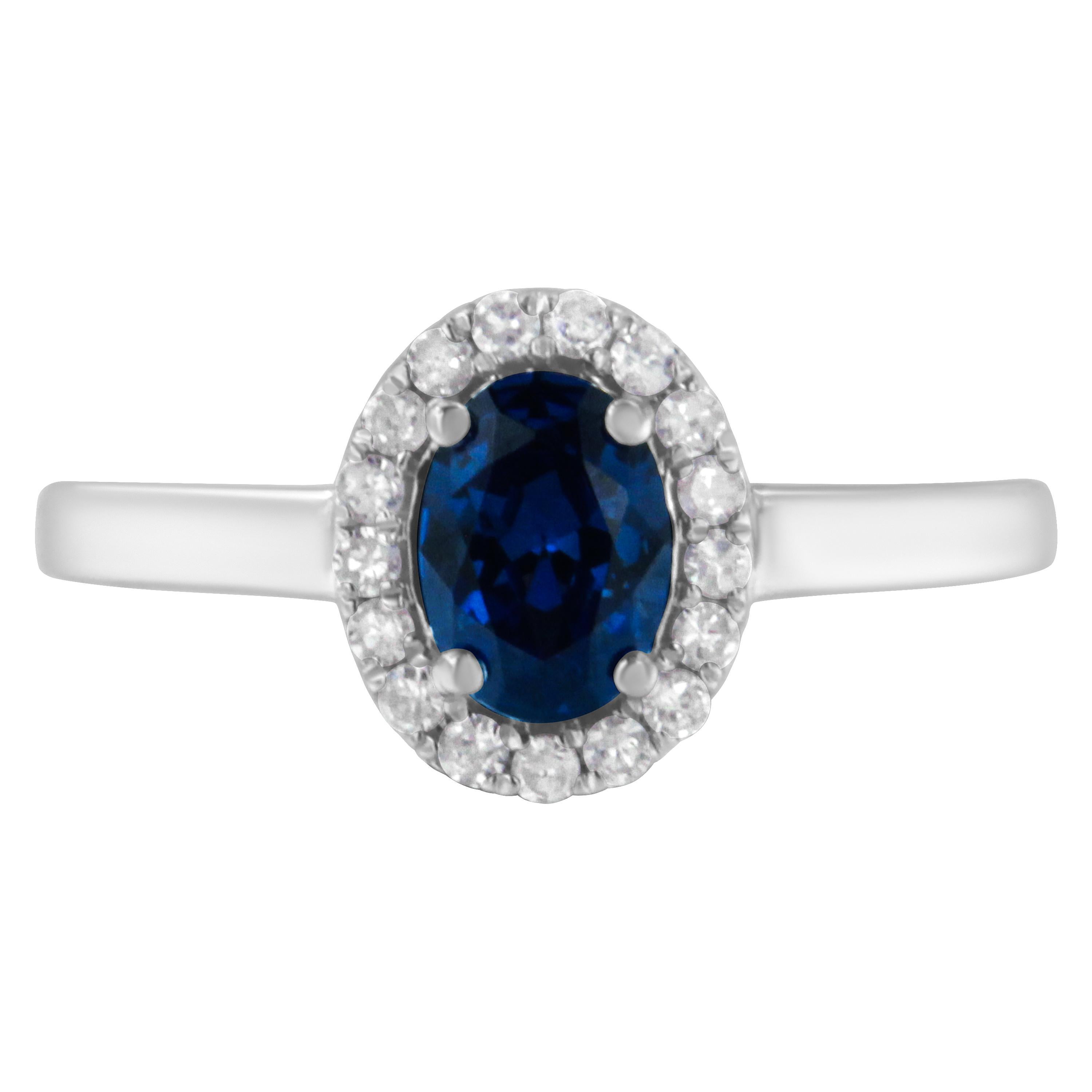 This dazzling 10k white gold ring features a 1 1/4ct deep blue oval sapphire. A brilliant halo of 1/5ct round cut diamonds frame the blue gemstone highlighting its natural glow.

Product Features: 

Diamond Type: Natural White Diamonds
Diamond
