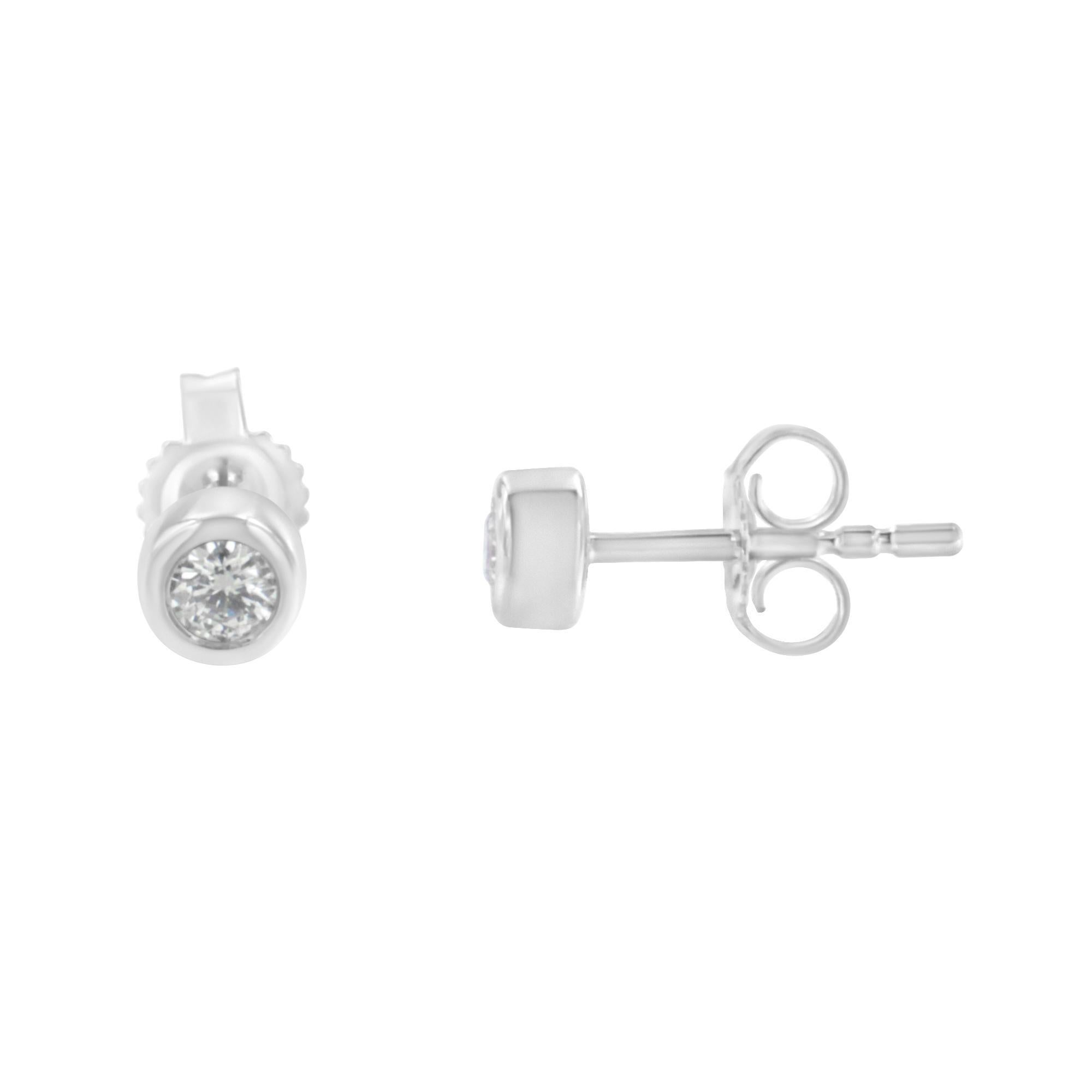 Shine like a diamond by wearing these elegant stud earrings. Fashioned in a contemporary bezel frame, these earrings are stunningly crafted from 10 Karat gold, with near-colorless natural diamonds nestled in the center. Butterfly push-backs on
