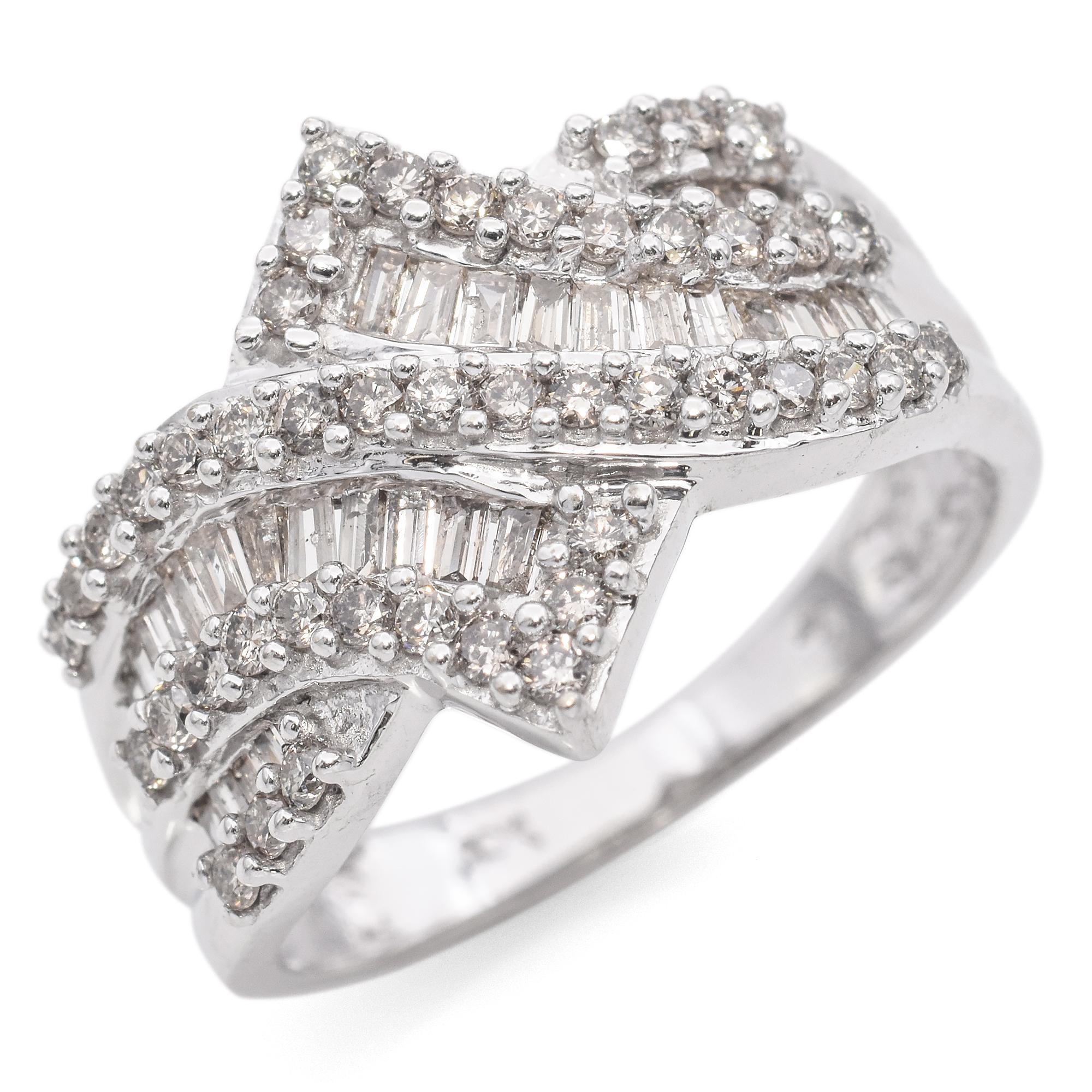 This beautiful ring features a mix of round brilliant and baguette-cut diamonds intricately set in a wave-like pattern. The diamonds are set in a polished white gold band, creating a shimmering effect.

Weight: 4.4 grams 
Stone: Round cut 0.67tcw;