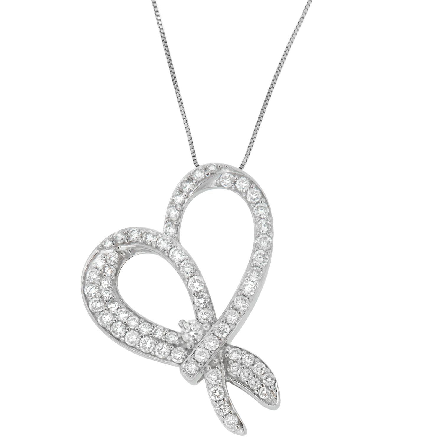 Embrace your feminine side with this radiant heart bow pendant. Chiseled to perfection, the piece of jewelry is crafted of 10 karats white gold and is finely polished with grace. It is adorned with gleaming one karat of round cut diamonds, which is