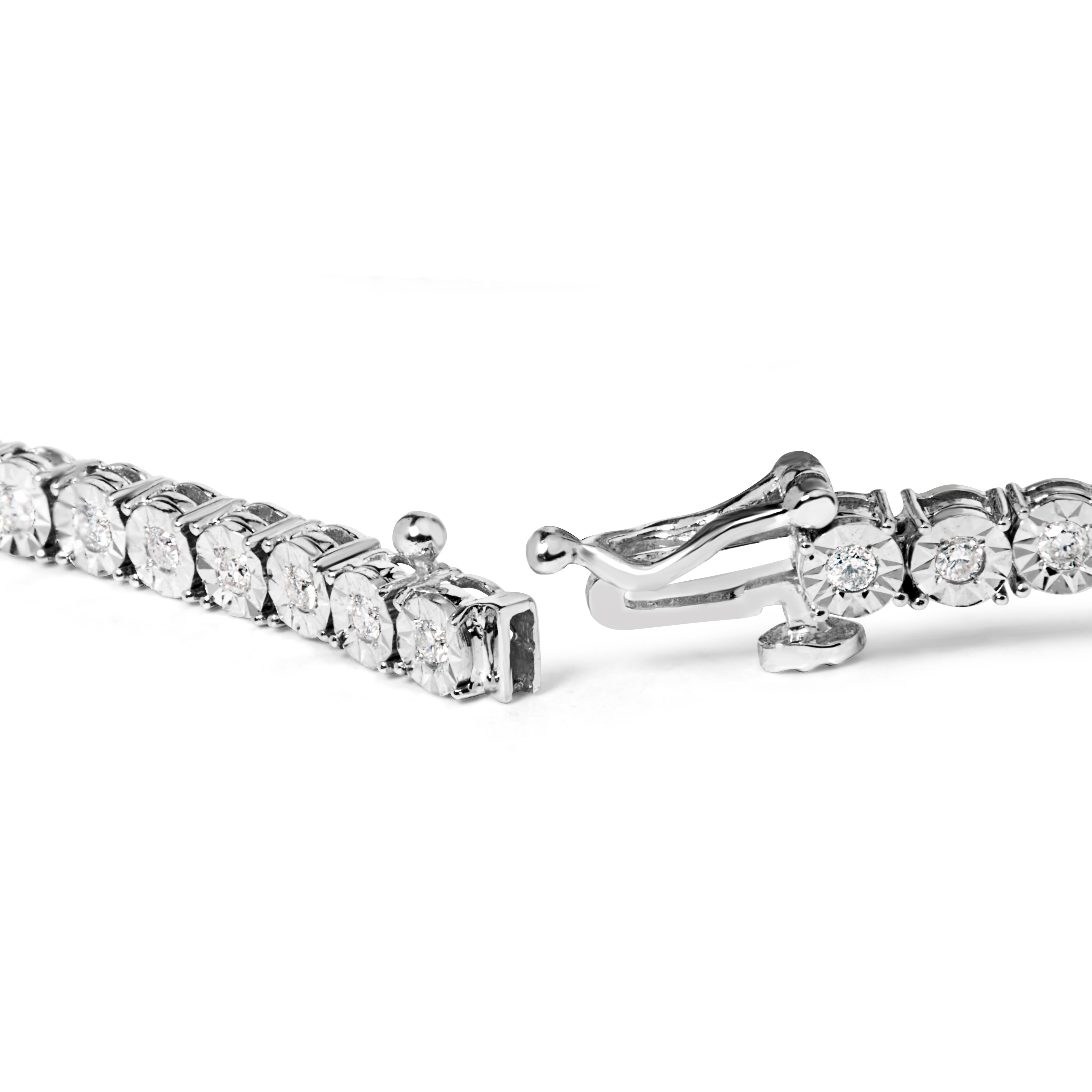 Indulge in the shimmering beauty of this elegant diamond tennis bracelet, crafted with 10k white gold. Its 48 natural round-cut diamonds totaling 1.0 cttw are carefully selected for their I-J color and SI2-I1 clarity, forming a stunning procession