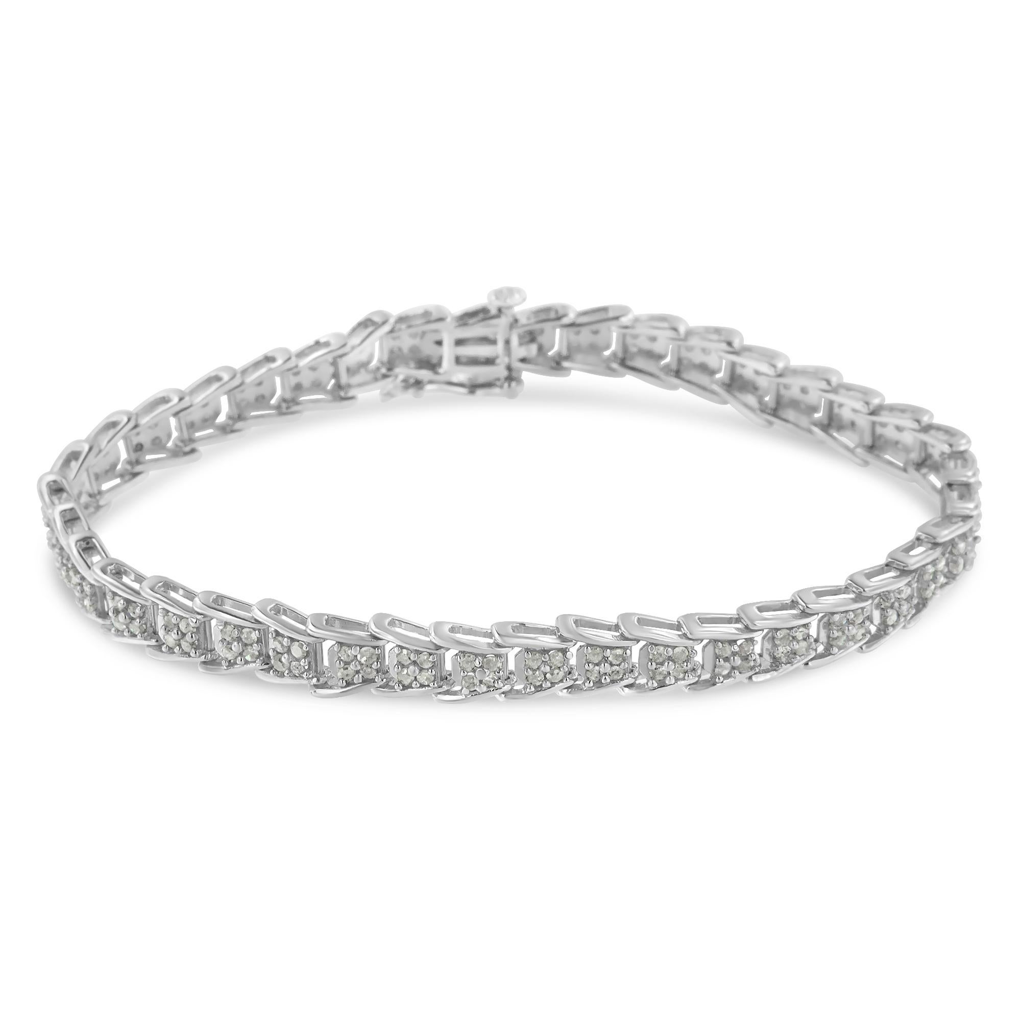 Crafted in 10k white gold, this stunning tennis bracelet features 2ct TDW of glittering round cut diamonds. Each link is inlaid with four prong set diamonds and fans out to fit onto the next one creating a unique effect. A box clasp mechanism keeps
