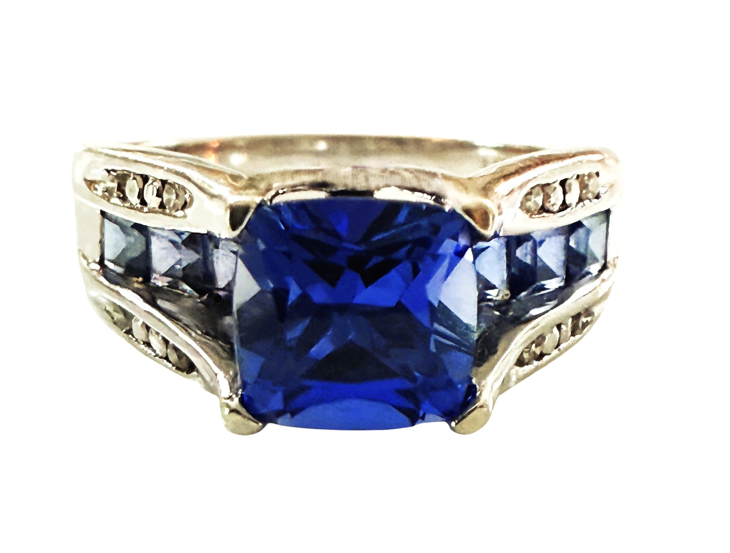 This ring is so gorgeous!  The Tanzanite stone is so beautiful.  The main Tanzanite stone is 7 mm square and is 1.96 carats.  It has 3 square cut tanzanite stones running down each side of the band that total .36 carats.  Together the ring has 2.32