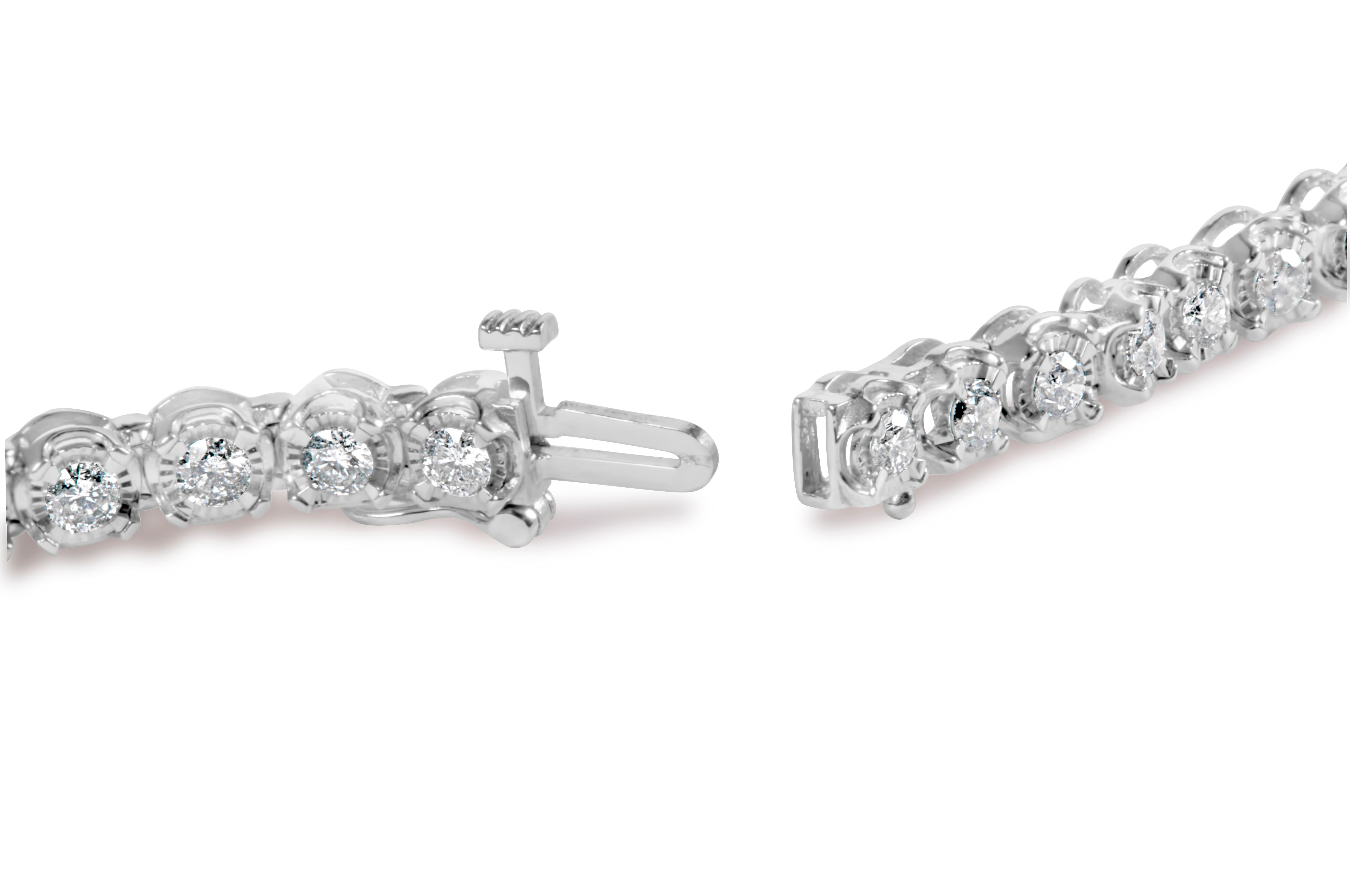 Indulge in the ultimate luxury with this stunning 10K white gold tennis bracelet. Adorned with 3.00 cttw of natural diamonds, this piece is an absolute showstopper. The miracle set bezel design creates an illusion of larger diamonds, making this