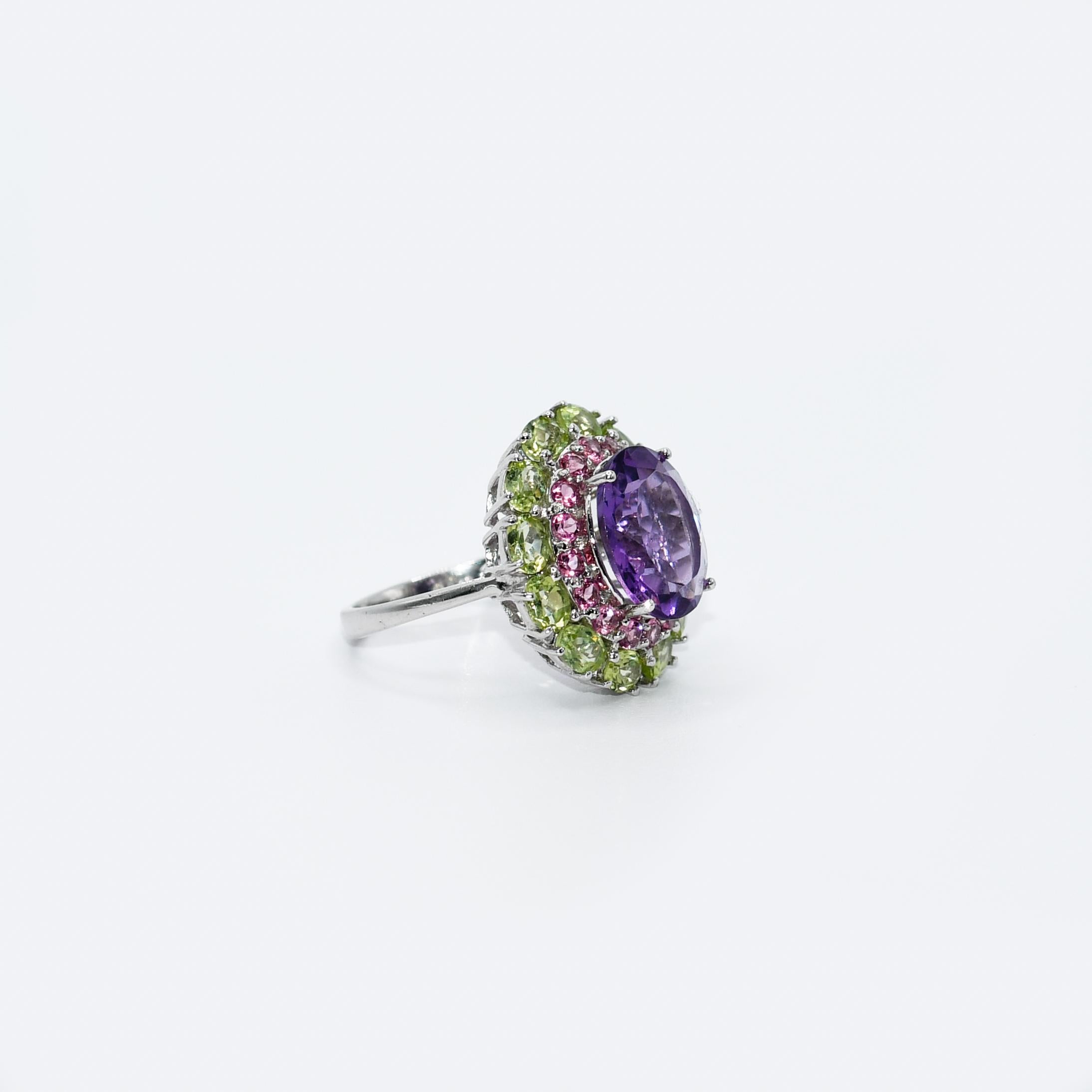 Ladies amethyst and pink tourmaline ring in 10k white gold setting.
Stamped 10k and weighs 5.4 grams gross weight.
The center stone is an oval-shaped, purple amethyst, 3.50 carats.
On the sides are round brilliant cut, pink tourmalines, .50 total