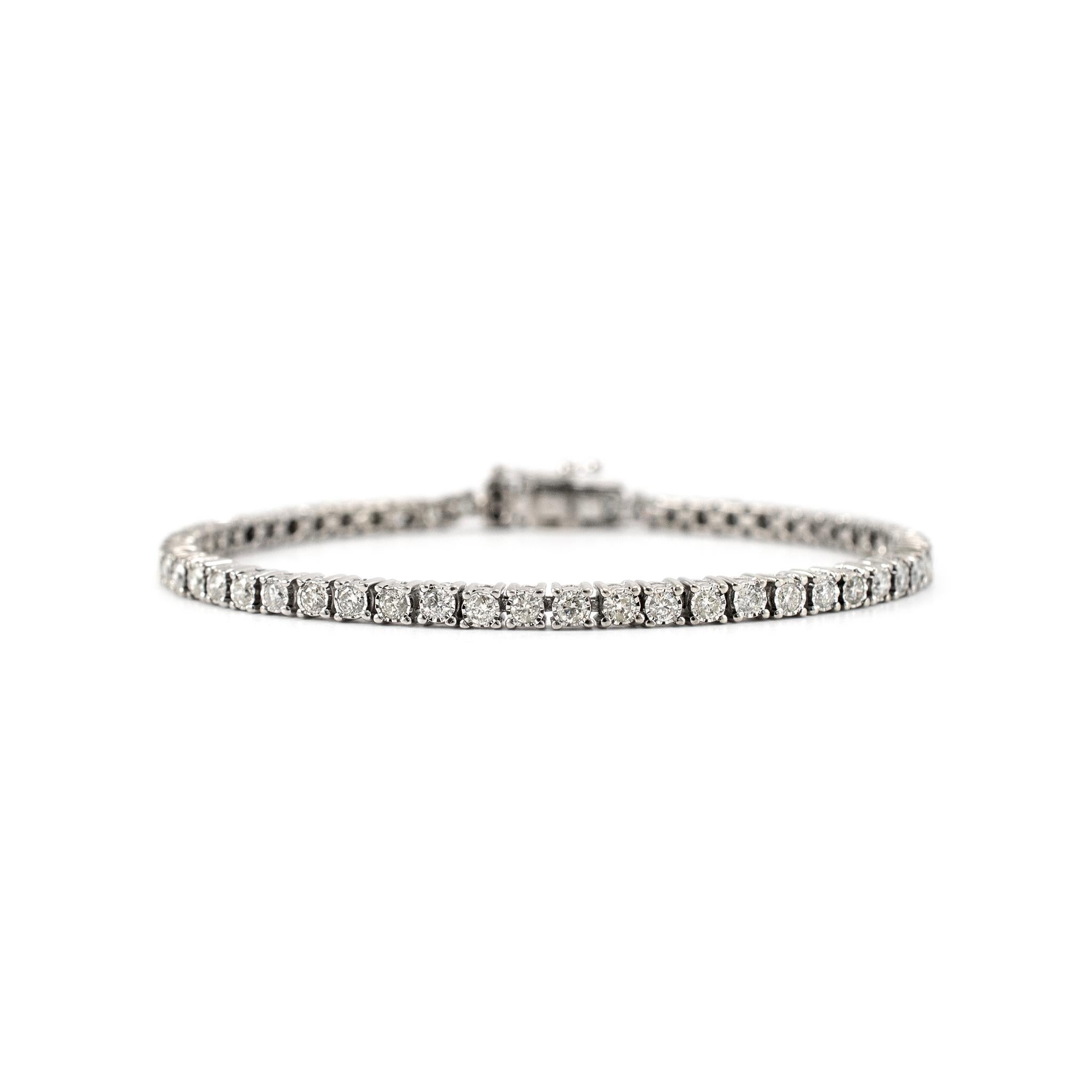 Gender: Ladies

Metal Type: 10K White Gold

Length: 7.00 inches

Width: 3.10 mm

Weight: 9.22 Grams

One ladies custom made polished 10K white gold diamond tennis bracelet. The metal was tested and determined to be 10K white gold. Engraved with