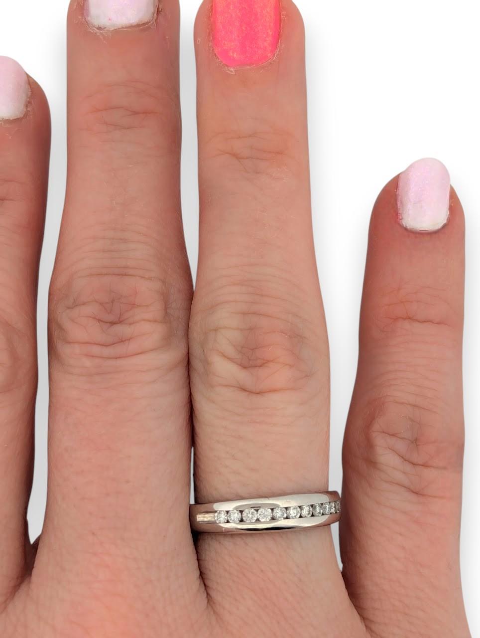 This elegant 10K white gold ring features .25 CTW of natural round diamonds in a classic channel setting, offering a sleek profile with just the right amount of sparkle. Perfect as a wedding band, anniversary ring, or a timeless stacking piece, this