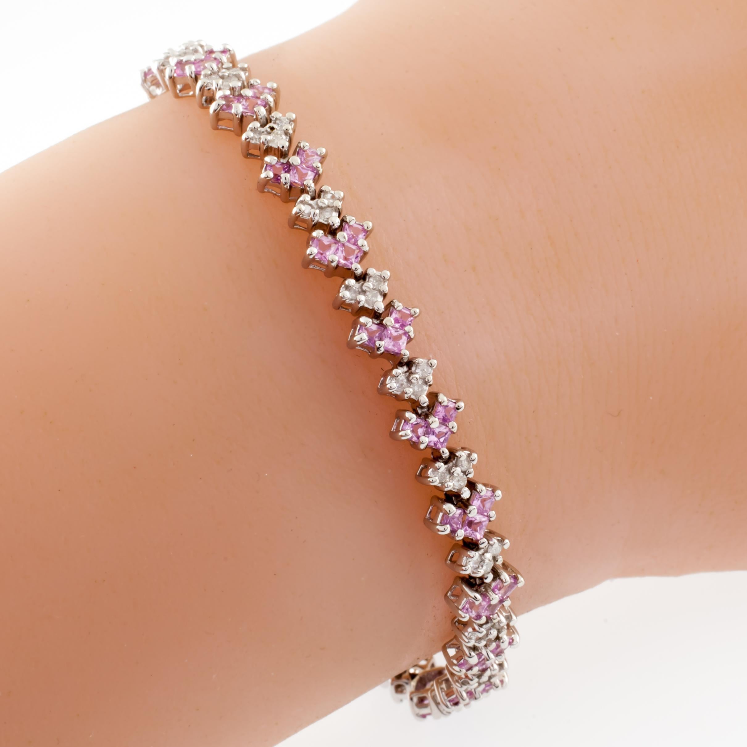 Gorgeous 10k White Gold Bracelet
Features Alternating Heart-Shaped Florets of Diamond and Pink Amethyst
Cushion Cut Amethyst & Round Cut Diamond
Total Amethyst Weight = Appx 6.90 ct
Total Diamond Weight = Appx 1.38 ct.
Average Color = I - J