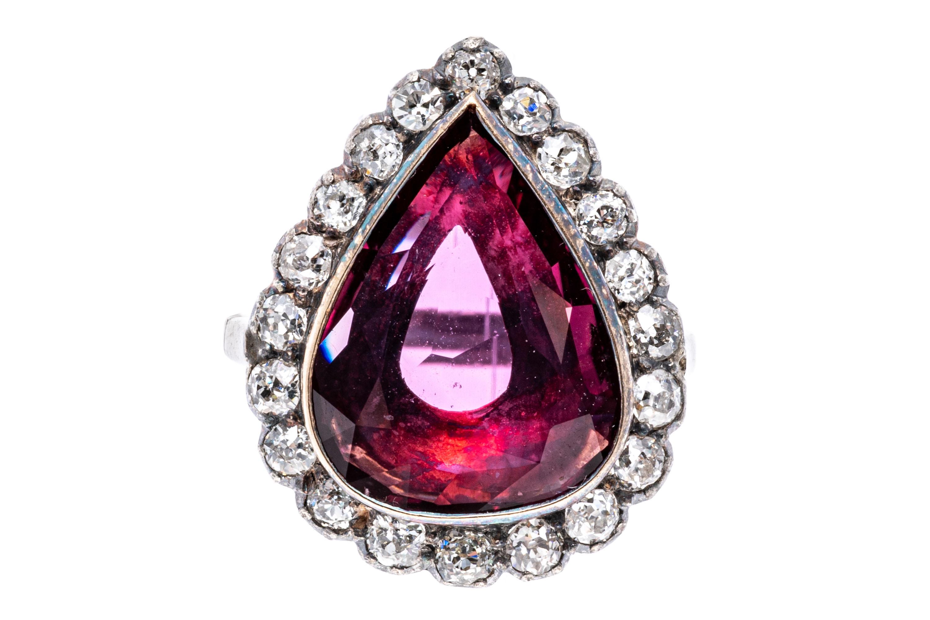 10k white gold ring. This beautiful vintage white gold ring has a center pear shaped faceted, reddish pink color ruby, approximately 2.71 CTS, bezel set and framed with a halo of old mine cut diamonds, approximately 0.30 TCW, prong set.
Marks: None,