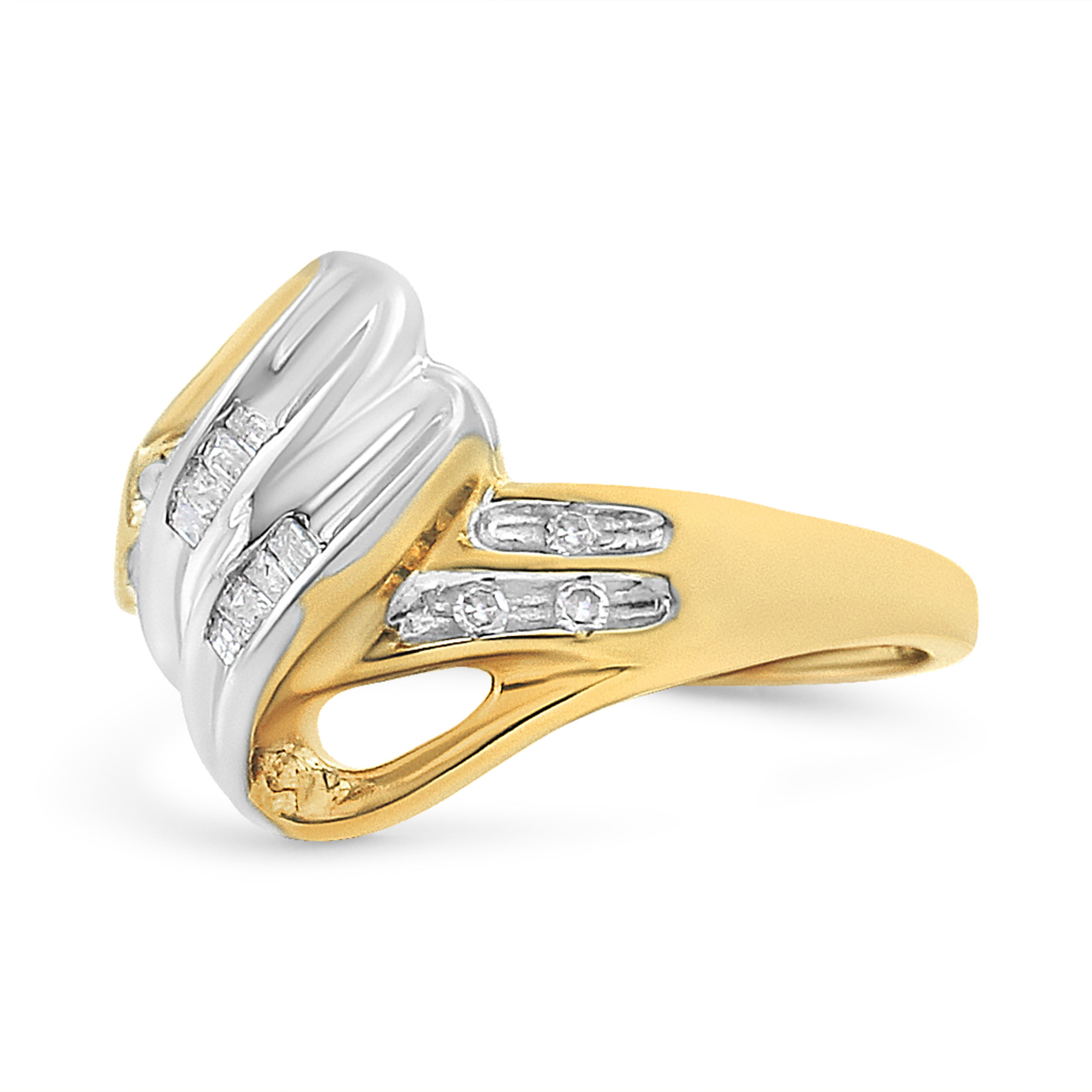 Beautifully designed, this bypass ring is expertly designed with 10k two tone gold and natural diamonds. The yellow gold band is vertically intersected by white gold at the middle. Baguette-cut diamonds are embellished onto the white gold, while