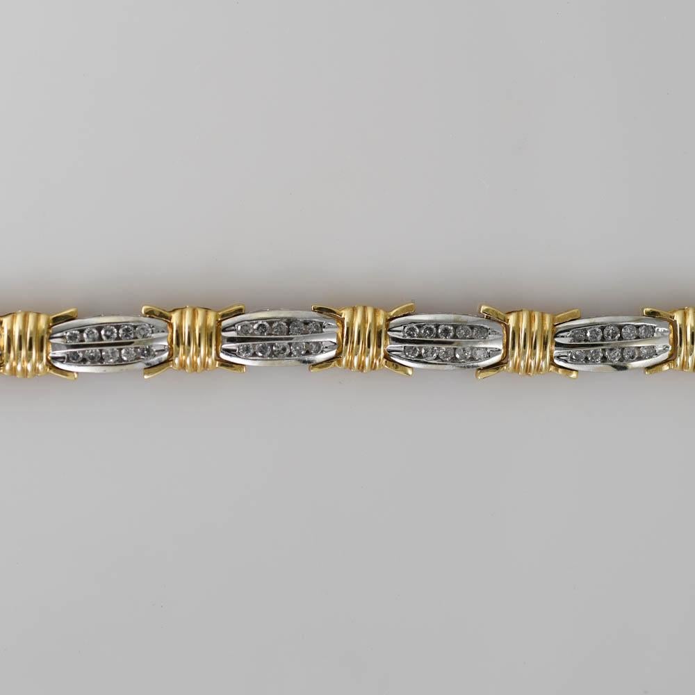 10 kt yellow and white gold diamond bracelet weighing at 12.80 grams
it contains 90 round brilliant diamonds 1.ct weight mounted in channel setting
it measures 6.5'' inches in length and 7mm width