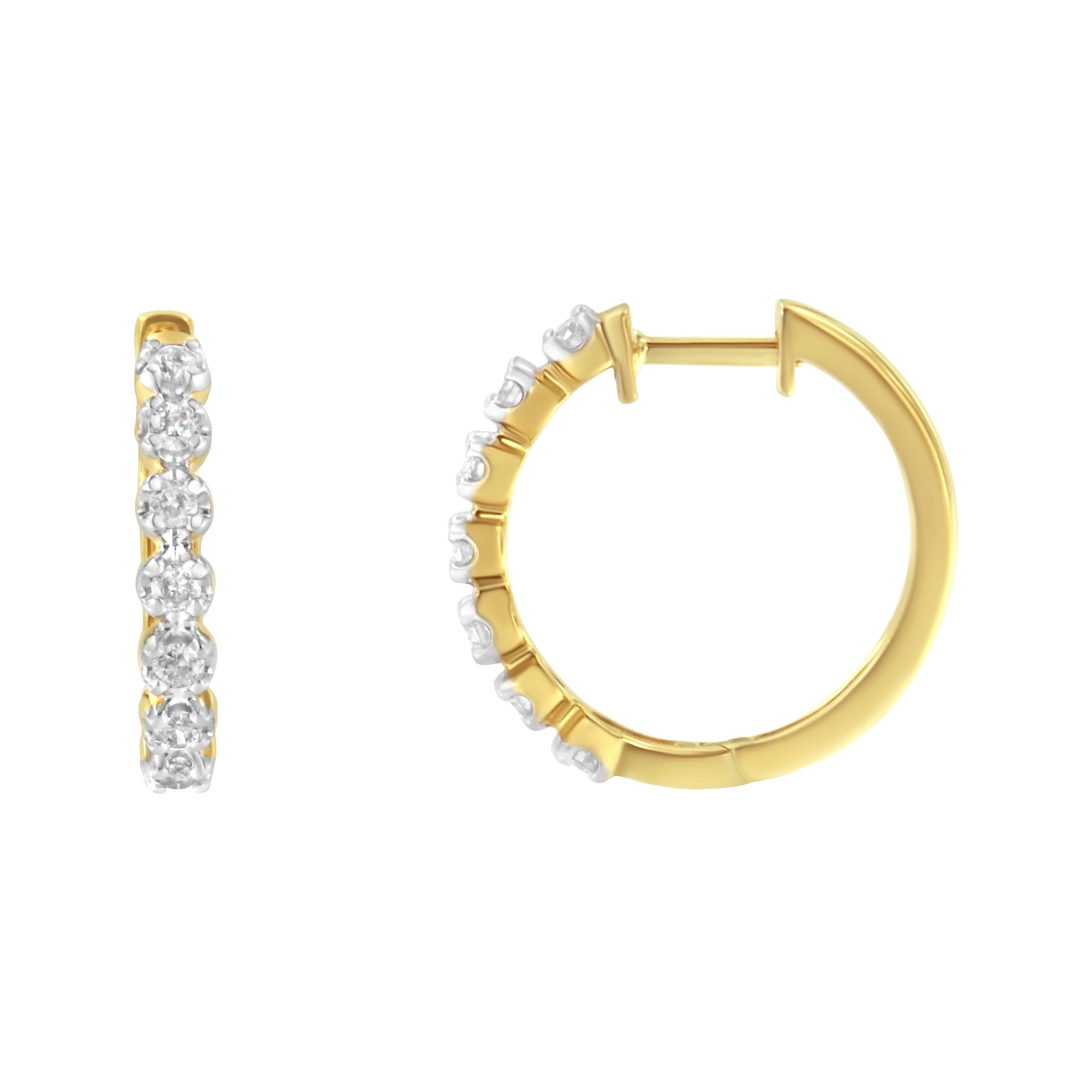 Fashioned in stunning 10k yellow gold, these beautiful huggy hoop earrings feature 1/2ct of brilliant round cut diamonds in a prong setting that delicately flow half way around the outside of the hoop. A classic piece you can wear everyday.

'Video
