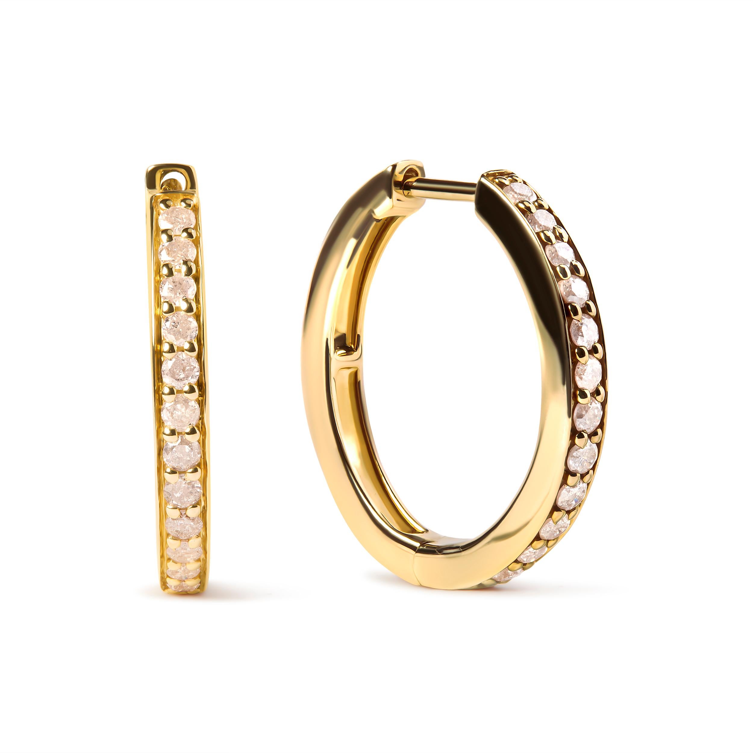 Embrace the allure of these 10K yellow gold hoop earrings, a perfect fusion of sophistication and style. With 24 natural round-cut diamonds totaling 1/2 cttw, these beauties sparkle with a breathtaking I-J color and I2-I3 clarity, secured in a