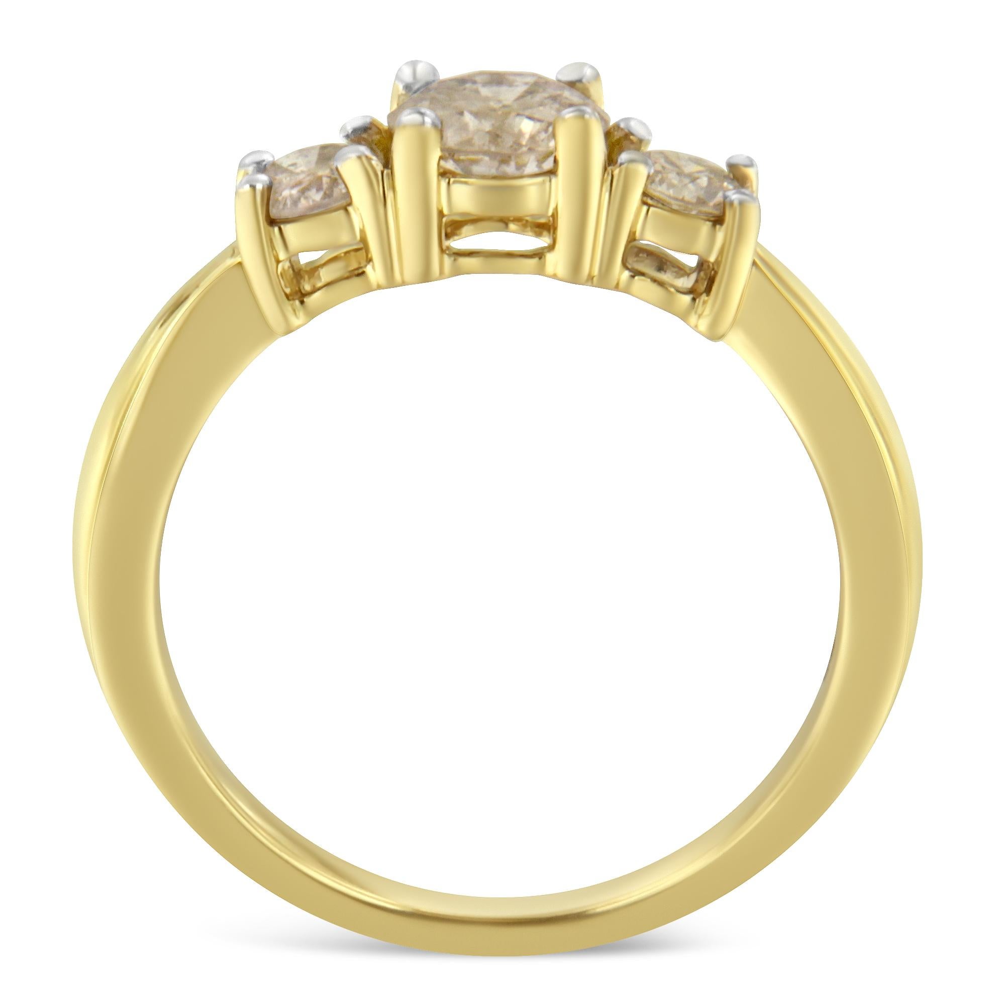 Beautifully crafted of 10-karat yellow gold, this stunning anniversary ring showcases one carat of diamonds in a classic three-stone design. The yellow gold band looks stunning on all skin tones, while the three center diamond stones are set in