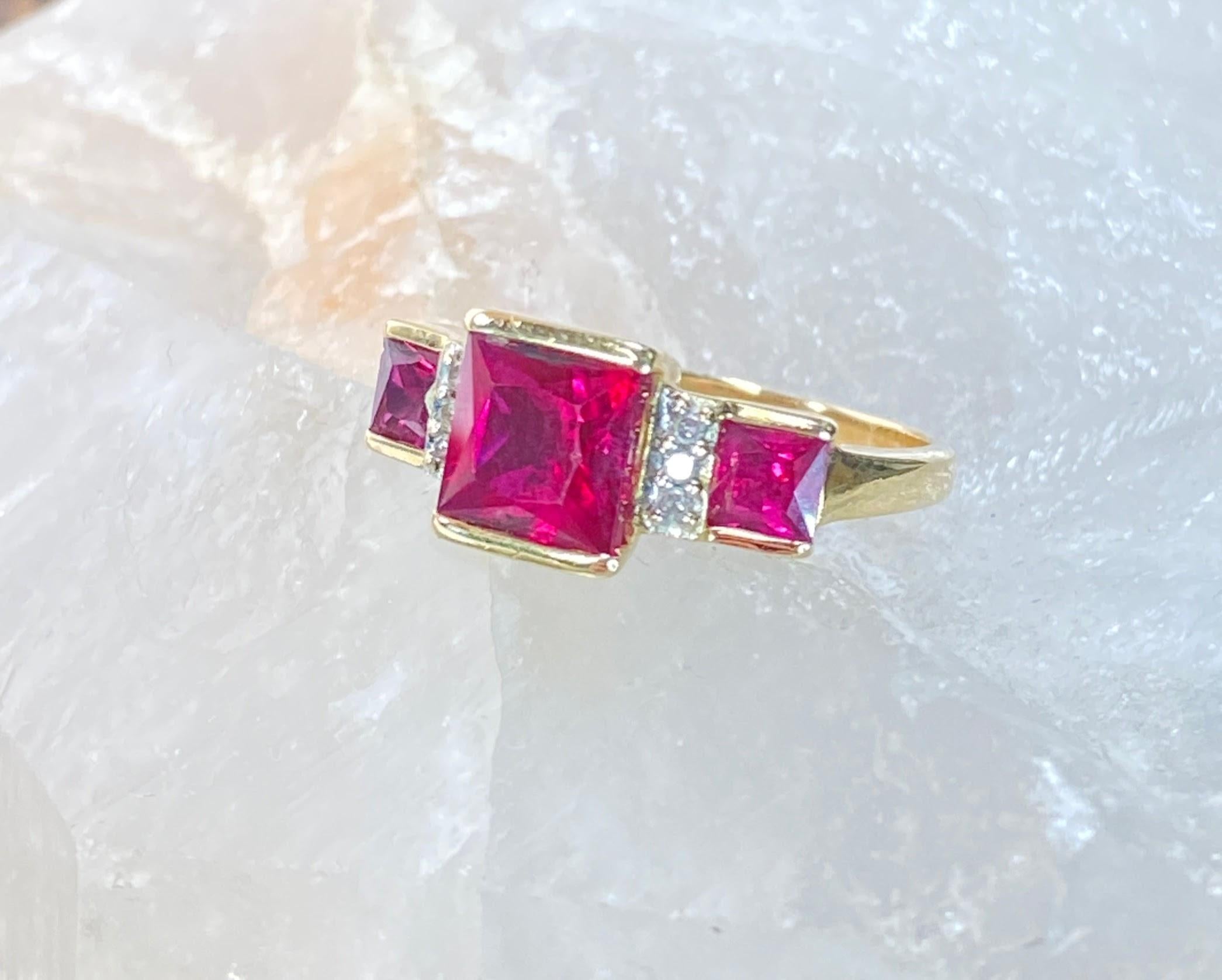 10K Yellow Gold 3 Carat Lab Princess Cut Ruby & Diamond 3 Stone Square Ring

This beautiful ring features 3 princess cut synthetic rubies, nestled in solid 10k yellow gold and accented by natural diamonds. With a total carat weight of 3.04 (by