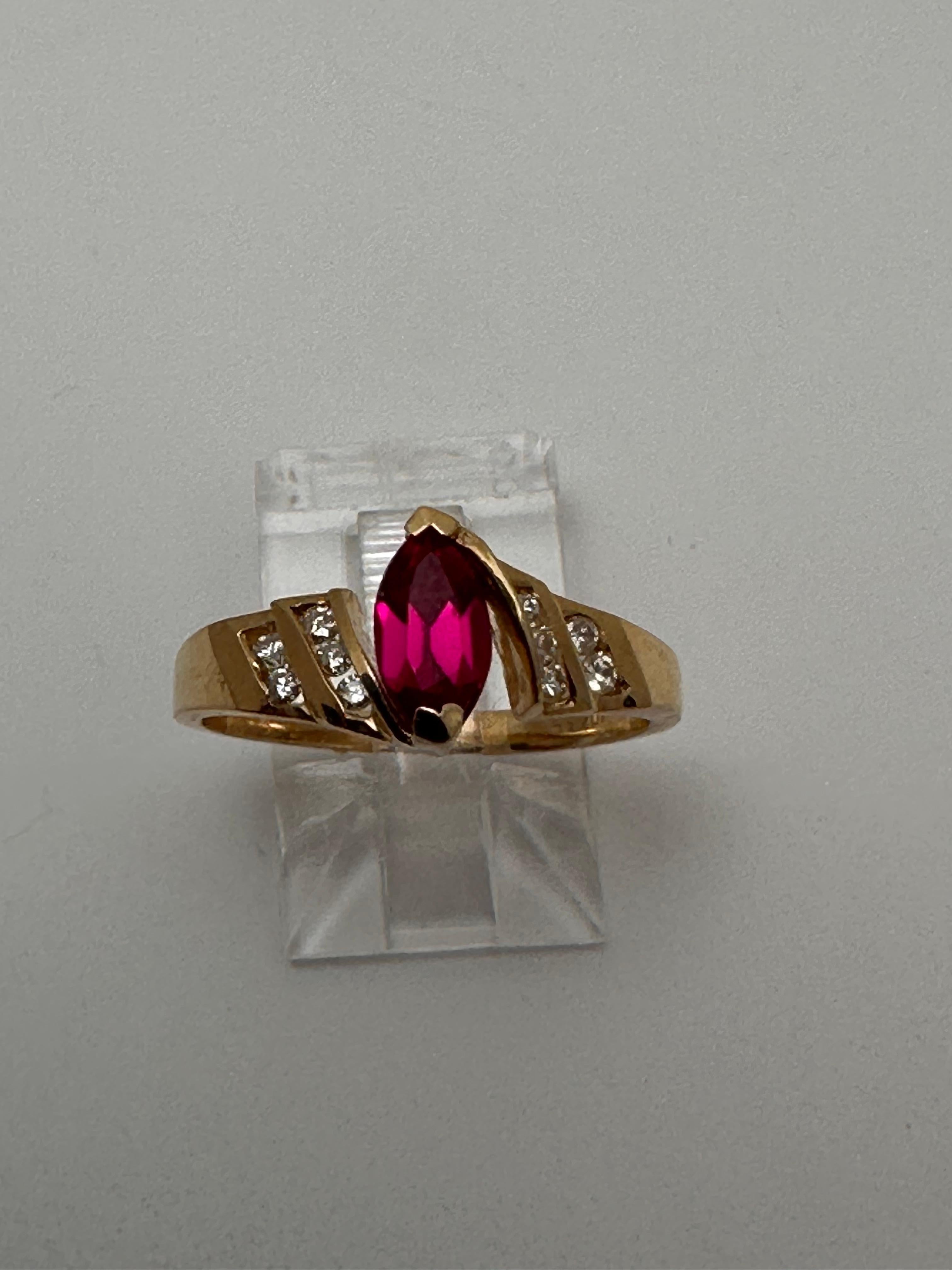 10k Yellow Gold approx. 4 x 8mm Marquise Ruby with 5 Channel Set Diamonds on each side of the ring ~ total 10 round diamonds.
Size 7

The ruby is known as a protective stone that can bring happiness and passion into the life of the wearer. Apart
