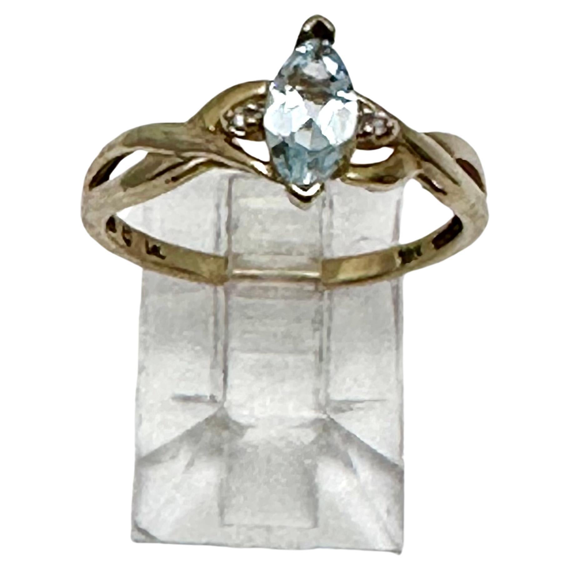 10k Yellow Gold 4mm x 8mm Marquise Blue Topaz 
2 Diamonds ~ Ring Size 7

Blue Topaz Meaning:

This vivacious blue gemstone is known as the stone of clarity. The Blue Topaz meaning allows you to channel your inner wisdom and find the perfect pathways