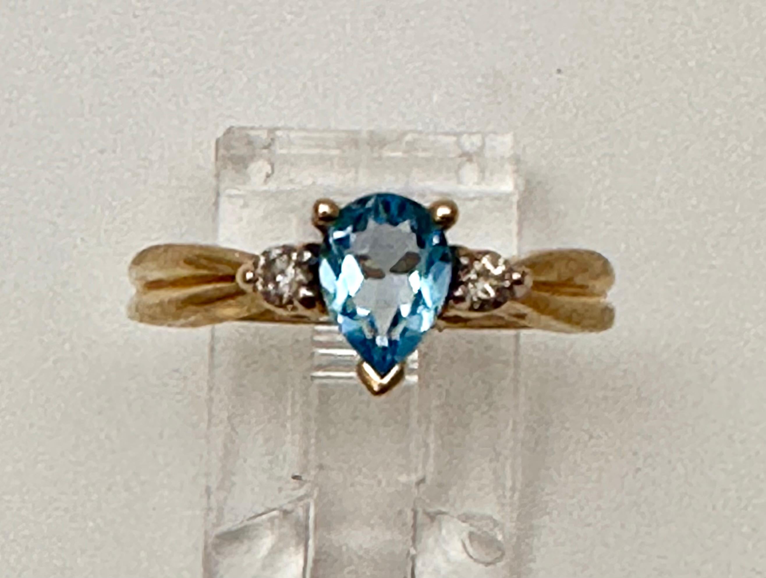 10k Yellow Gold approx. 5mm x 7mm Pear Blue Topaz with 2 sparkly Round Diamonds
Ring Size 7

Blue Topaz Meaning
This vivacious blue gemstone is known as the stone of clarity. The Blue Topaz meaning allows you to channel your inner wisdom and find