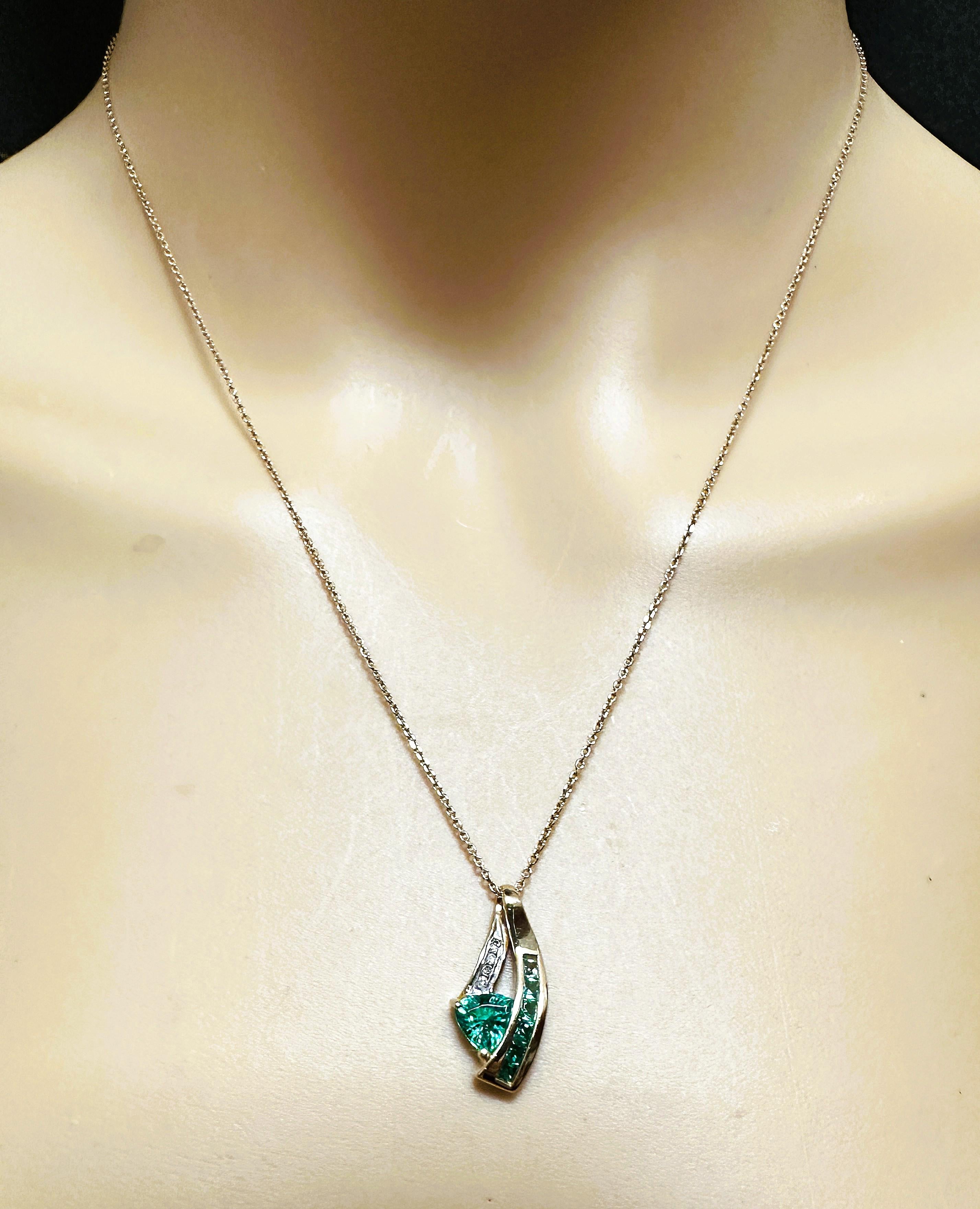 This is a very pretty pendant.  It is pre-owned and in excellent condition.  It's been very well-cared for.  It has 6 square shaped emeralds ranging from 2.25 mm to 1 mm and they total .80 carats.  It also has 4 brilliant cut diamond accents