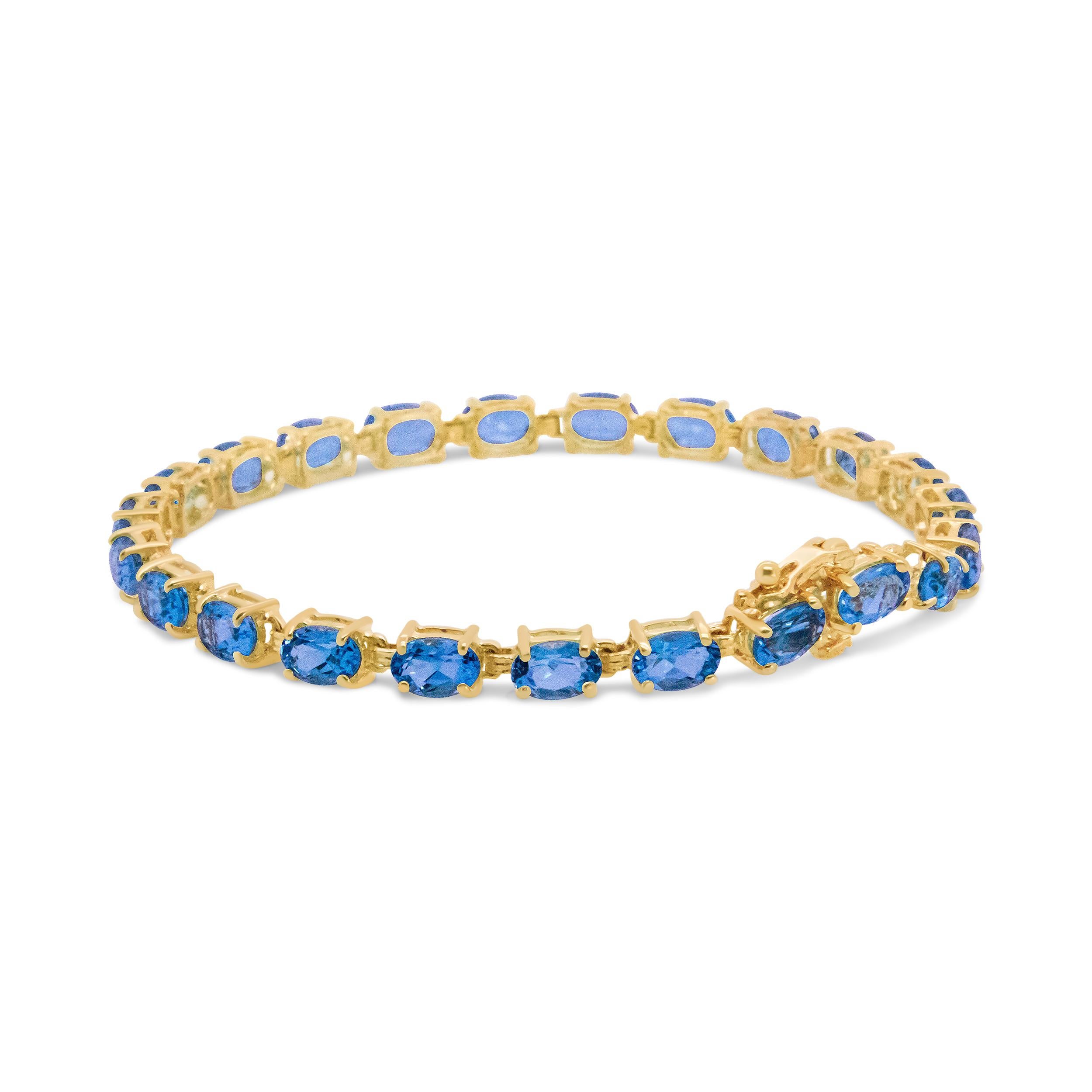Wrapped in luxurious gold sits stunning oval shaped topaz stones on this one-of-a-kind bracelet. The 10k yellow gold shines against the deep blue color of the topaz gemstones for a polished and glamourous look. This piece should be considered an