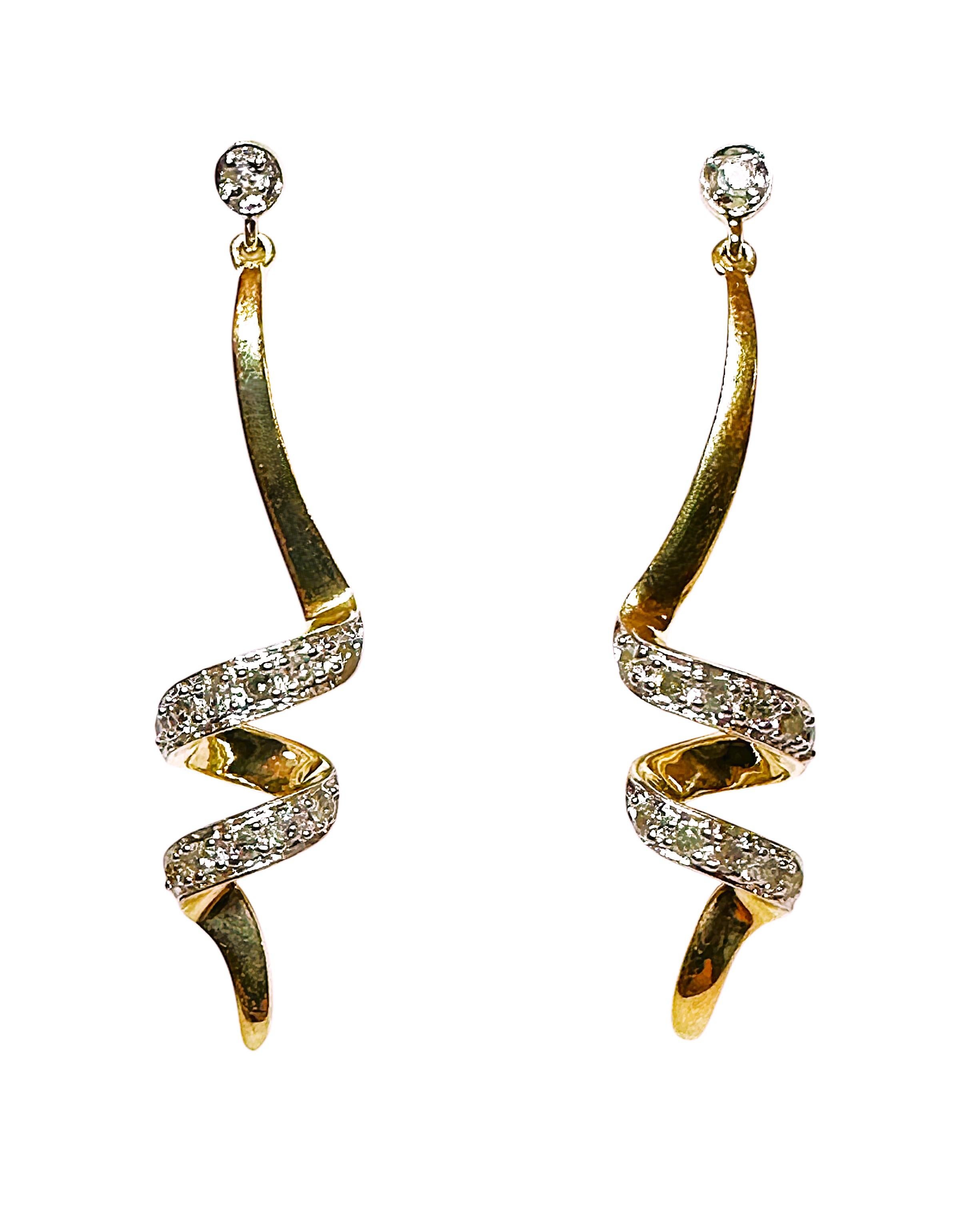 These earrings are just beautiful!  They are 10k yellow gold post earrings.  There is a 2.25 mm Diamond at the very top and the earrings swirl around with each swirl decorated with sparling diamonds.   The earrings measure 1.38 inches long and .38