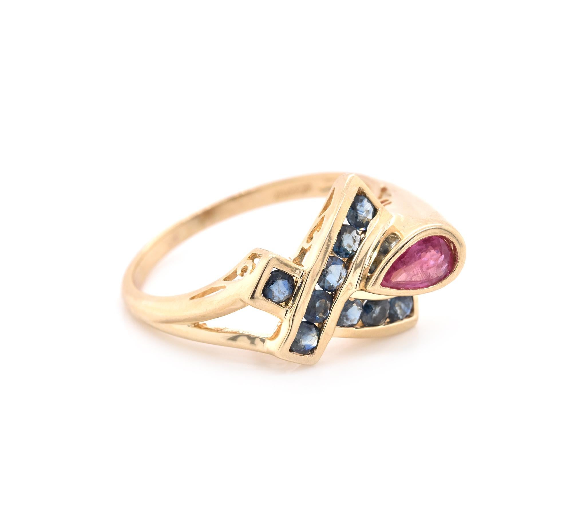 Designer: custom design
Material: 10k yellow gold
Gemstone: 9 round blue sapphires and 1 pear cut pink sapphire
Ring Size: 9 ¾ (please allow two additional shipping days for sizing requests)
Dimensions: ring top measures 19.15mm x 13.30mm
Weight: