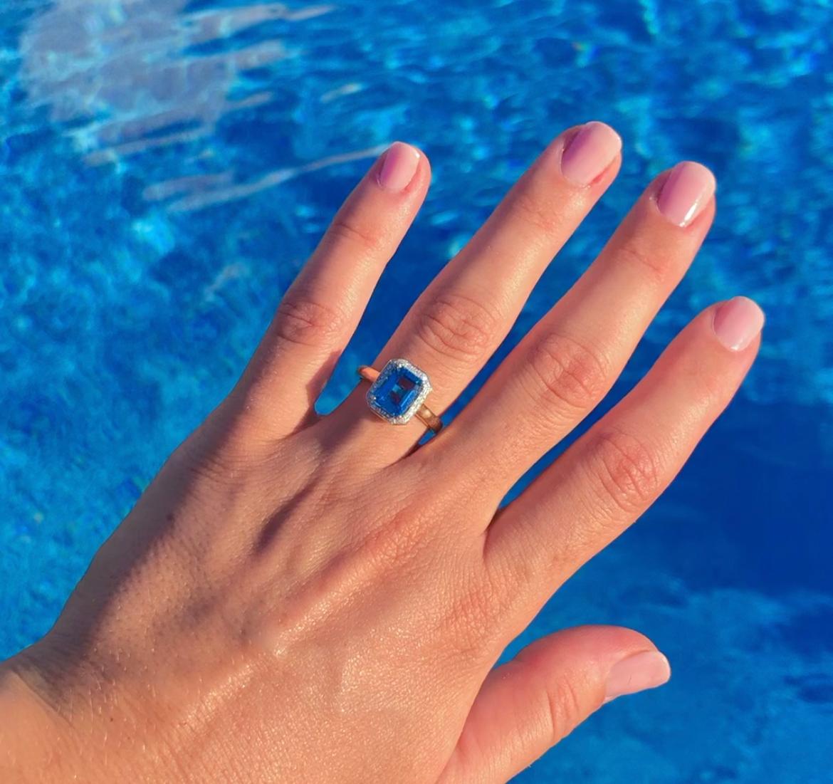 Discover the stylish design of our gemstone rings including this beautiful cocktail ring. The Blue Topaz Ring features a diamond halo. Perfect as a gemstone engagement ring, promise ring, something blue, or a fashion ring.

Diamond weight: 0.11 ct