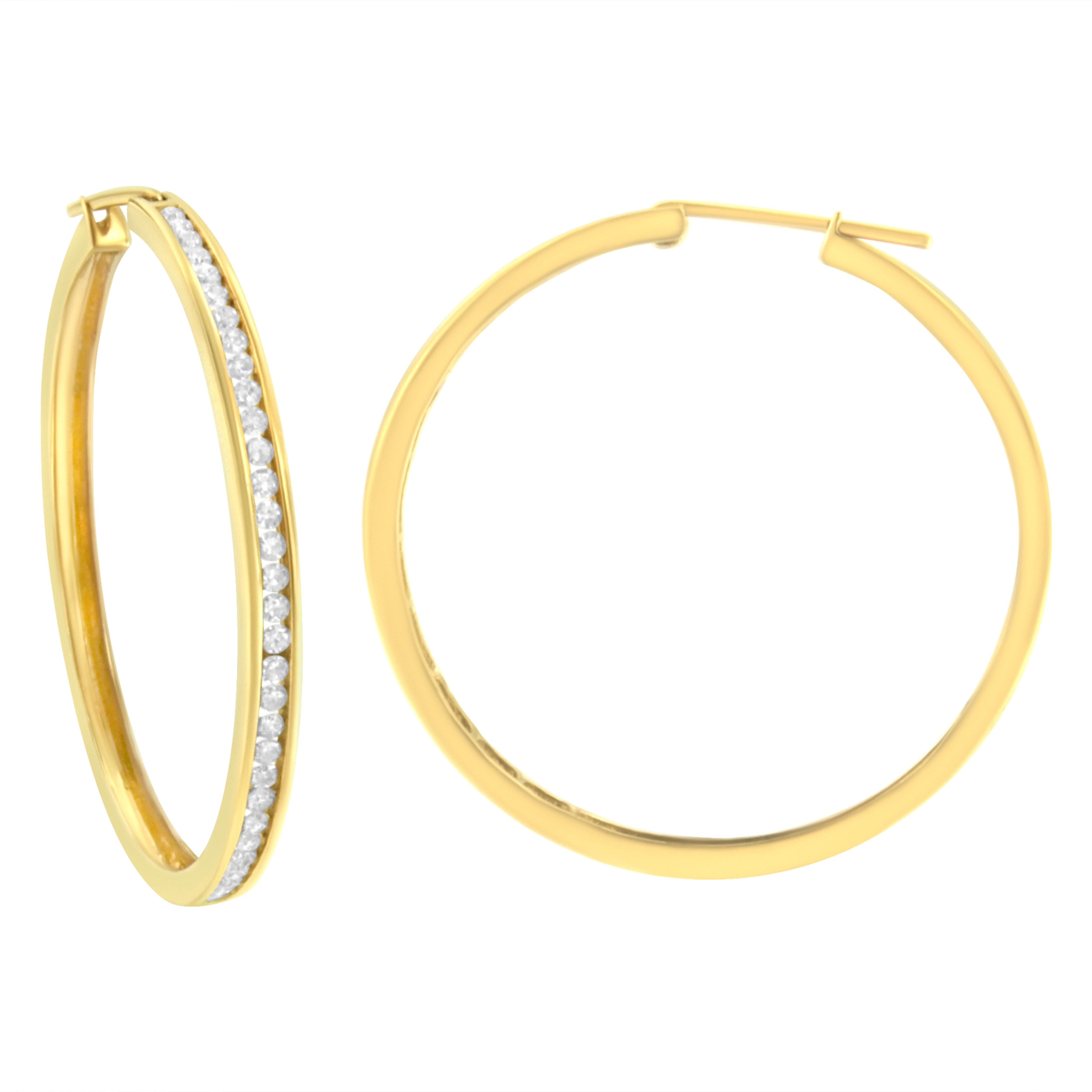 You can't go wrong with these classic 1ct TDW diamond hoop earrings. Sixty six channel set, round cut diamonds sparkle against the warm tone of this 10k yellow gold design. A clip on mechanism keeps the earrings secure. These diamonds are color
