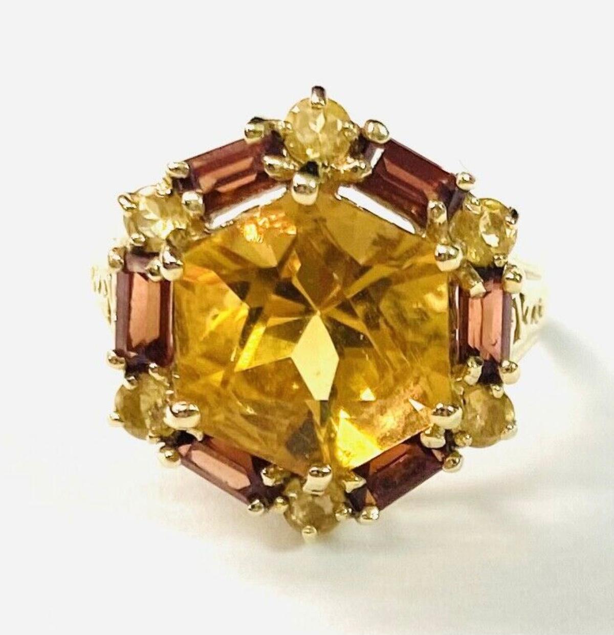 10k Citrine ring with baguettes, 4.14 Grams TW. The dimension of the round citrine is approximately 11mm. Approximately 7 carats. Marked 10k. Approximate size 6.5.
