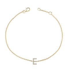 Pulsera de eslabones y dije de inicial "E" en oro amarillo de 10 quilates con detalles de diamantes