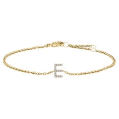 Pulsera de eslabones y dije de inicial "E" en oro amarillo de 10 quilates con detalles de diamantes