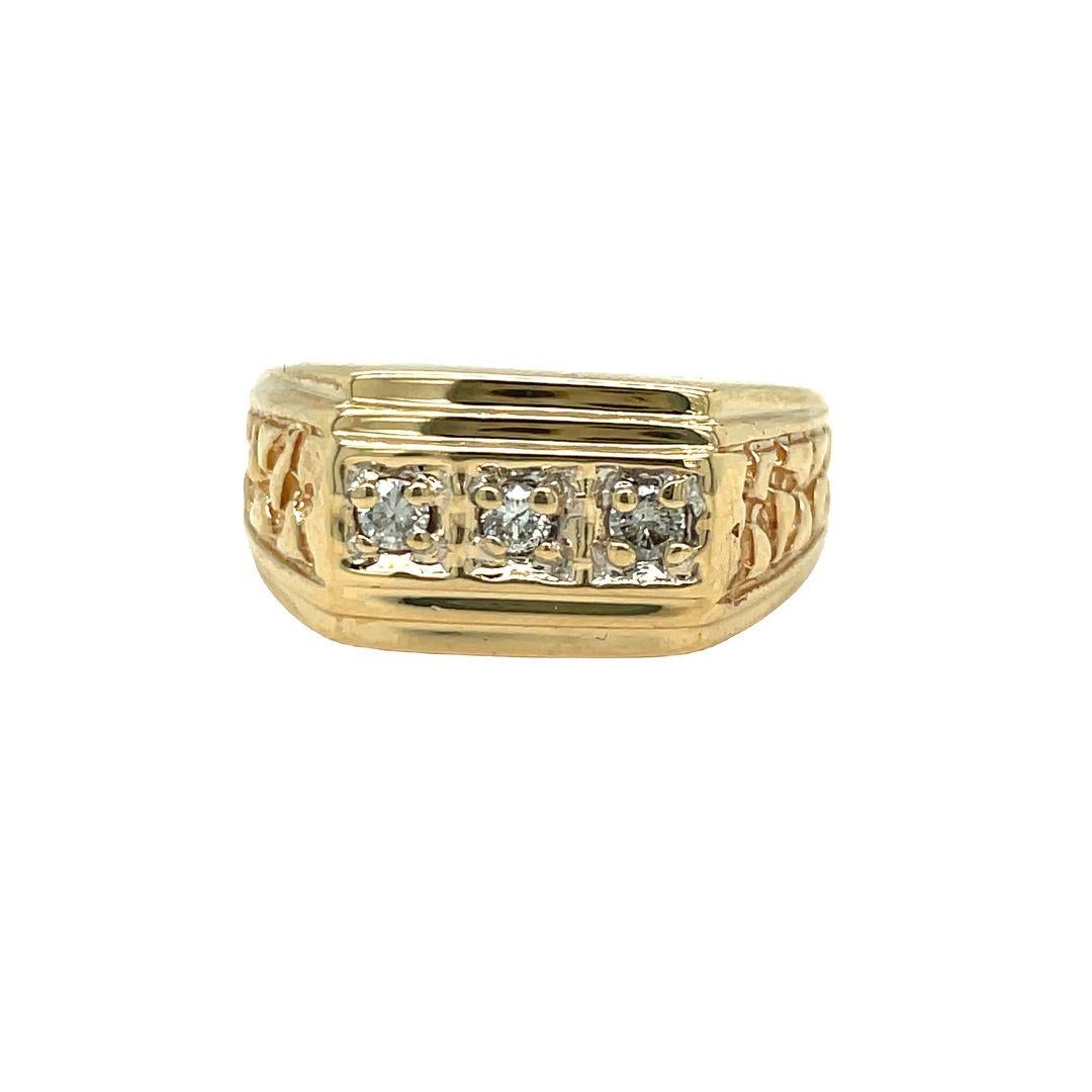 This 10K yellow gold men's ring is crafted with elegance. This masculine ring features round diamonds in the center and nugget detailing down the side of the band. The center of the ring has bead set three dazzling round brilliant cut diamonds,